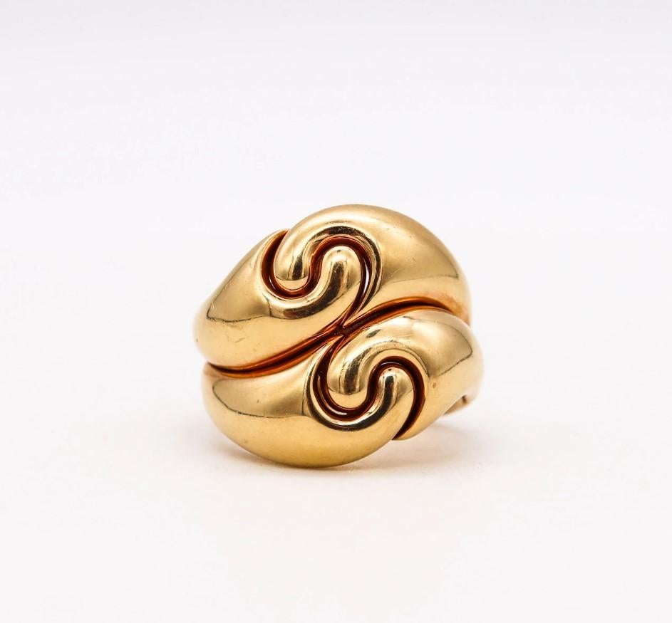 A doppio ring designed by Marina B. (Bvlgari).

Modern piece, created in Milan Italian by the jewelry house of Marina B. This doppio swirls ring was crafted with a double body shape in solid yellow gold of 18 karats, with high polished finish.

Has