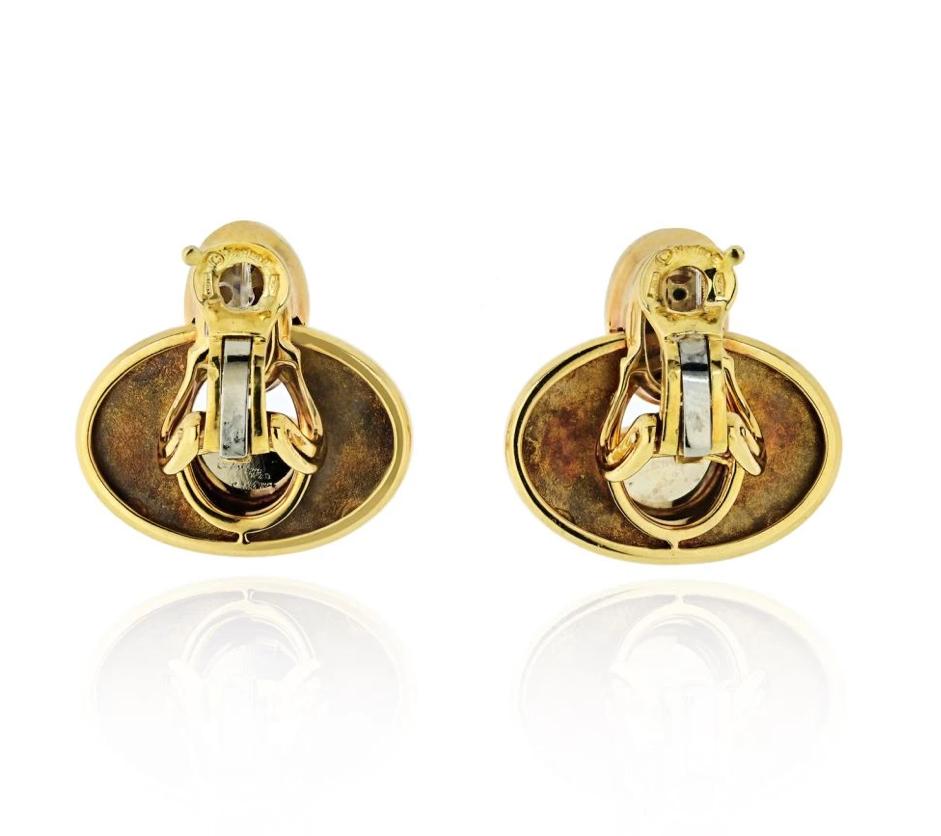 A chic pair of Marina B earclips featuring cabochon blue quartz mounted in 18 karat yellow gold.