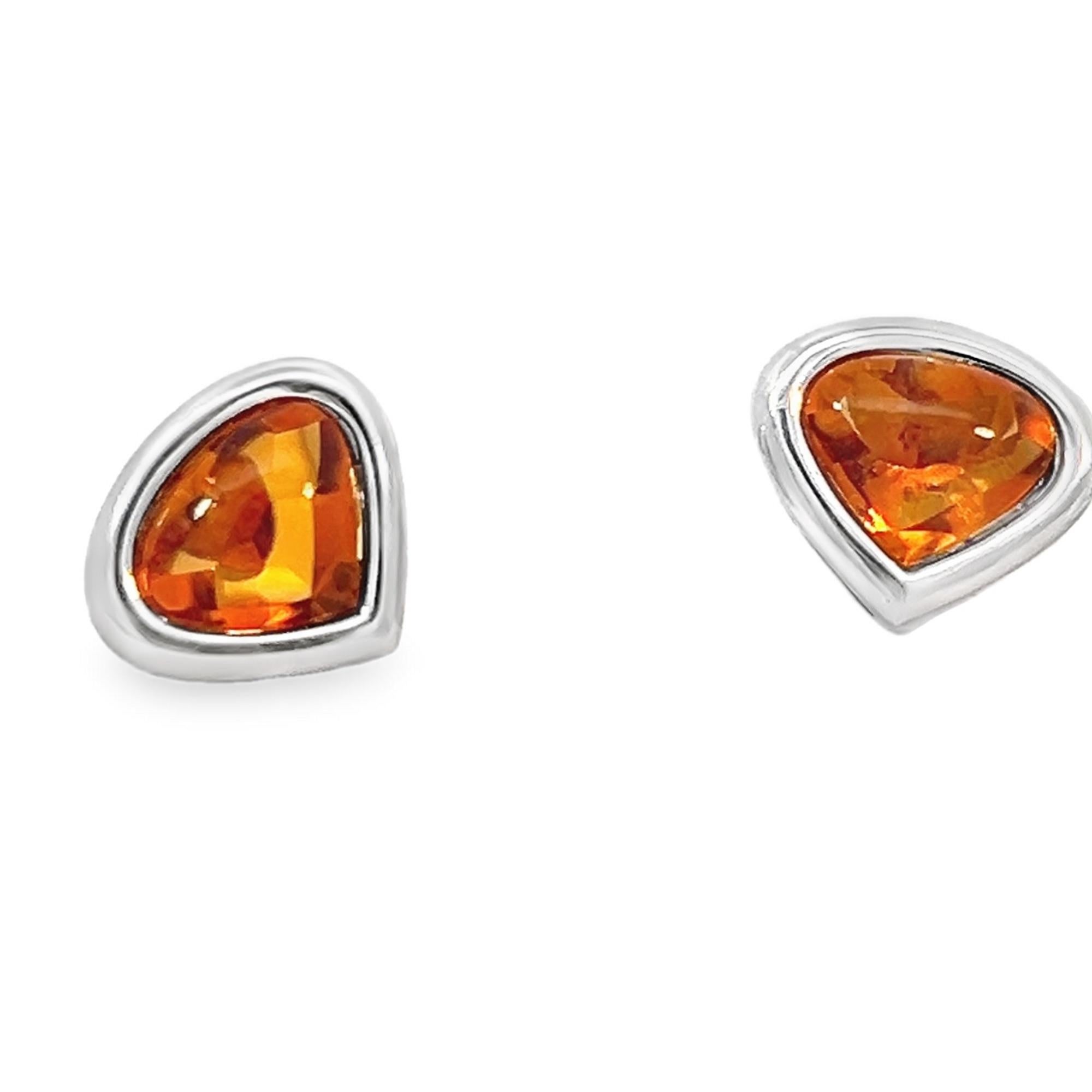 Marina B. orange citrine stud earrings bezel set in 18-karat white gold. These citrine earrings showcase a pear-shaped cabochon vibrant orange hue, set in a sleek 18-karat white gold frame. The earrings are signed by Marina B., an Italian designer,