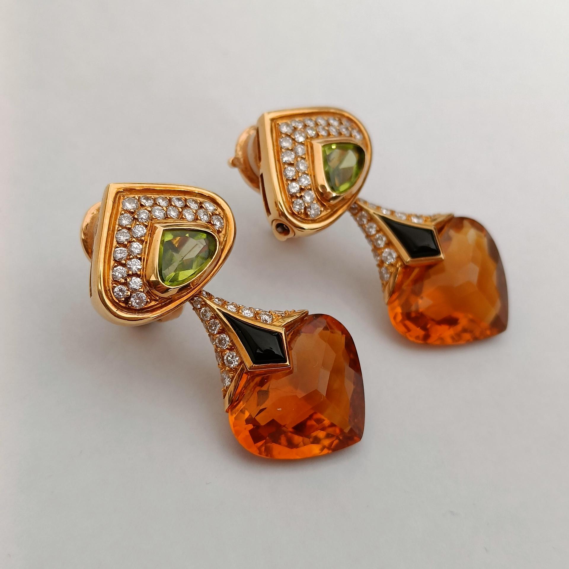 Marina B, a pair of 18k yellow gold pendant earrings (clip-on), adorned with a pear-shaped peridot in a closed setting topped with a pavé of brilliant-cut diamonds, holding a faceted pear-shaped citrine enhanced with onyx.

Signed Marina B, made in
