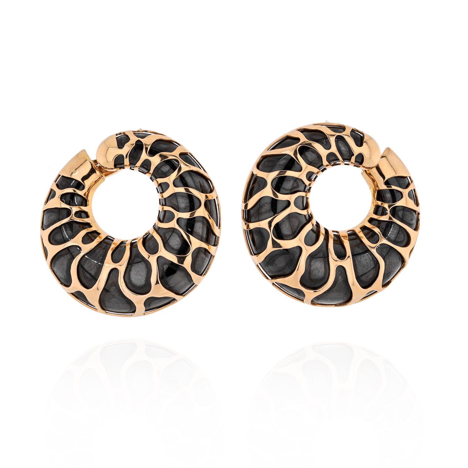 Make a bold statement with these hoop earrings created by Marina B in Italy in the 1989. Unusual combination of blackened metal and 18k yellow gold, giraffe motif pattern and voluminosity are the highlights of these stunning earrings.

They measure