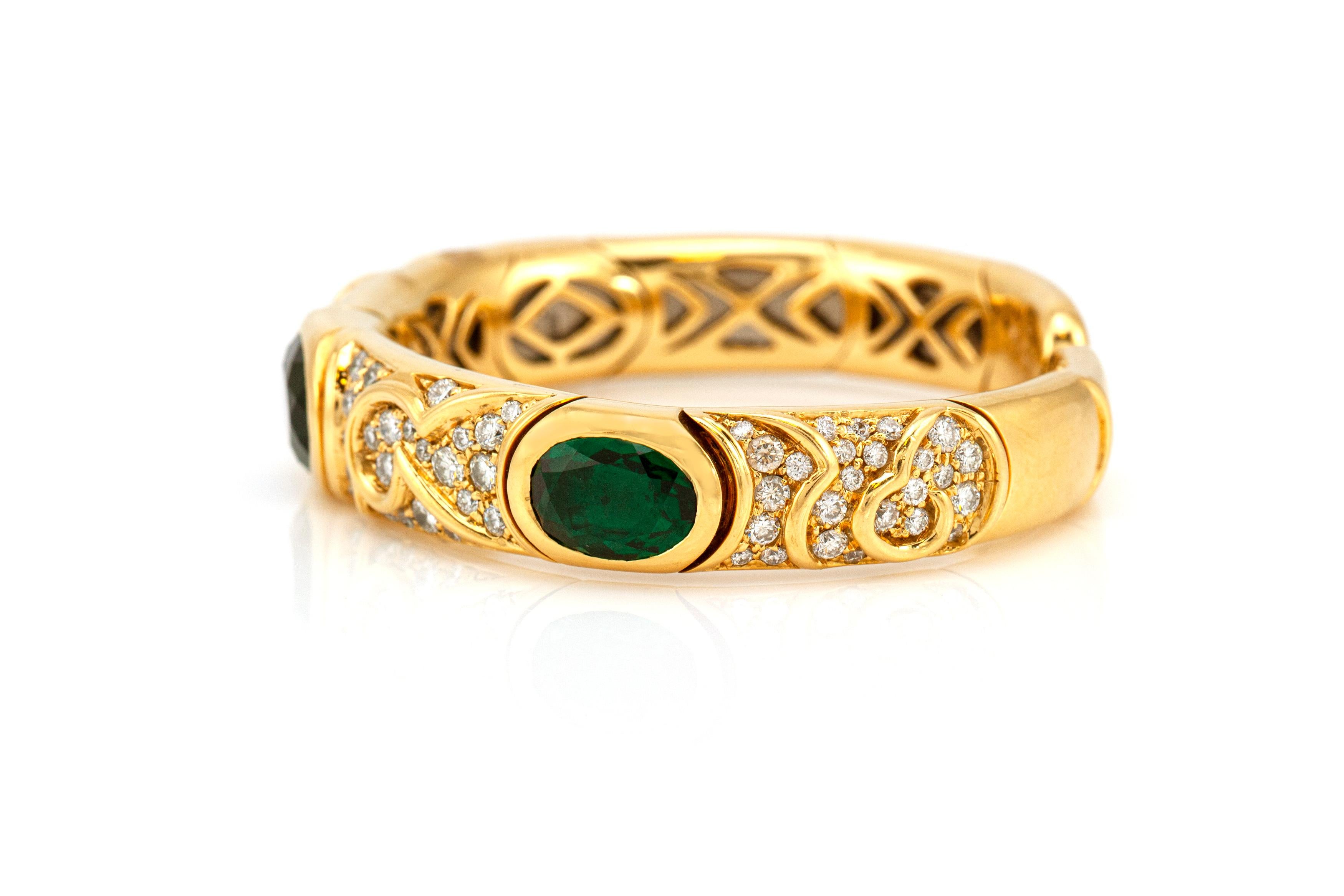 This beautiful Marina B cuff bracelet is finely crafted in 18K yellow gold with green tourmaline and diamonds. 
The diamonds weigh an approximate of 5.00 CT.