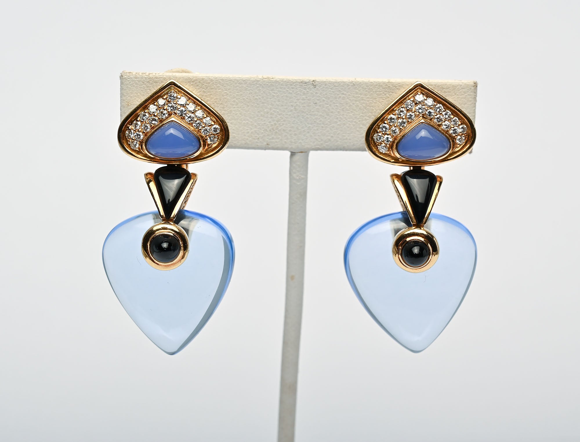 Totally stunning and versatile dangle earrings by Marina B of the famed Bulgari family. 
The top of the earrings is diamond studded with a triangular chalcedony . Below that are triangular  and round black onyx stones. The total length of the