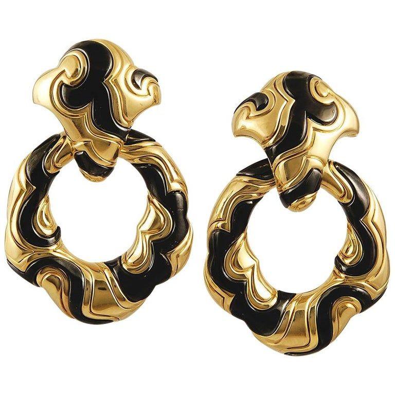 Iconic Marina B “Ken” earclips in yellow and blackened gold, in their original box. The pendants are detachable and can be worn as dress clips. Circa 1988.