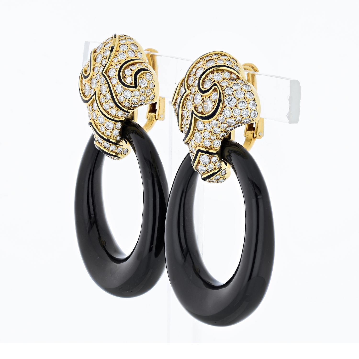 An iconic pair of ear pendants, named 'Ken' and resembling the shape of classic door knockers, mounted on 18kt yellow gold, tops are set with round cut diamonds between the black onyx scrolls, and smooth oval onyx door-knockers suspended from the