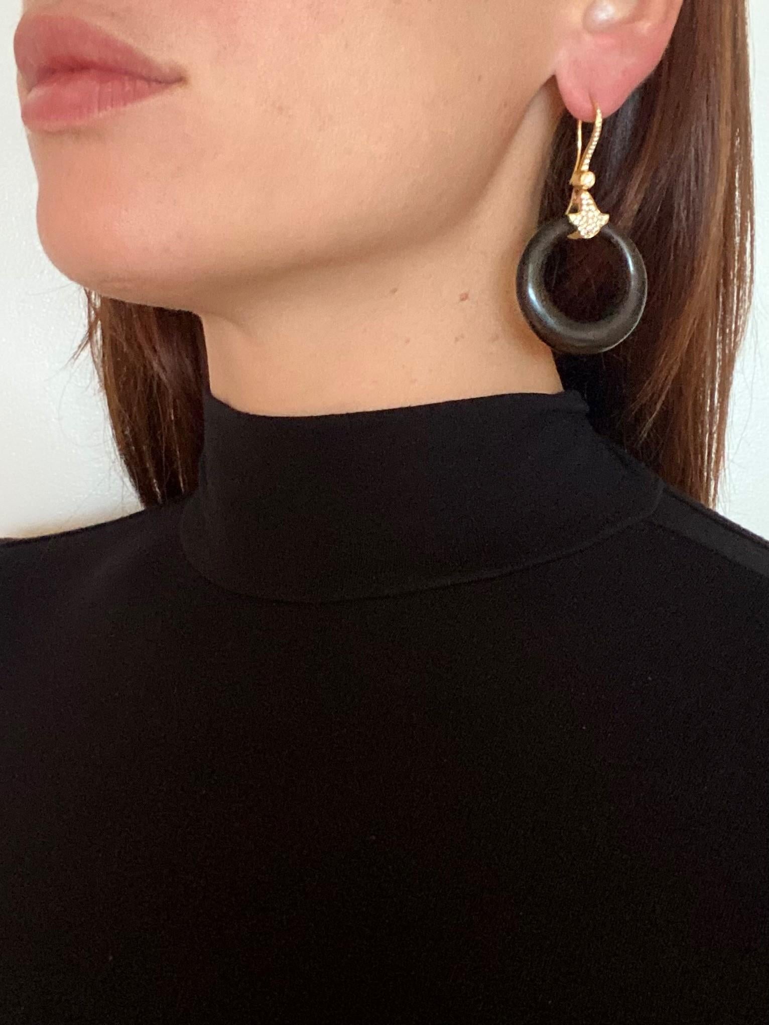 Convertible dangle earrings designed by Marina B.

Gorgeous convertible pair, created in Milano Italy by the jewelry house of Marina Bvlgari. These very versatile diamonds-set hoops earrings has been crafted in solid yellow gold of 18 karats with