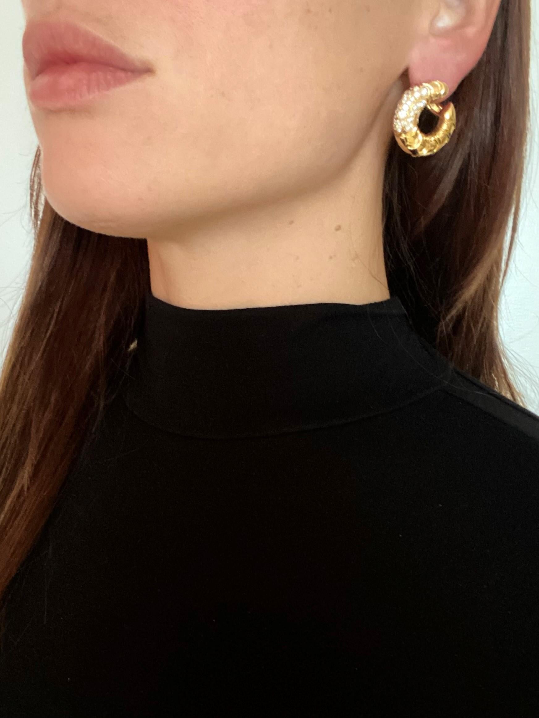 Swirled hoops earrings designed by Marina B.

Beautiful swirl pair created in Milano Italy by the jewelry house of Marina Bvlgari. These very versatile diamonds-set clips-earrings has been crafted with scalloped patterns in solid yellow gold of 18