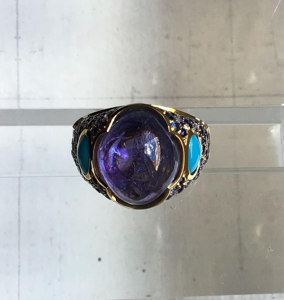 18-Karat Gold Lavinia Ring with 16.87 ct Tanzanite Cabochon, 3.82 ct Blue Pave Sapphires, 0.81 ct Turquoise, 0.11 ct Pave Diamonds.

Polished 18-karat yellow gold, size 7

Signed Marina B, Made in Italy

