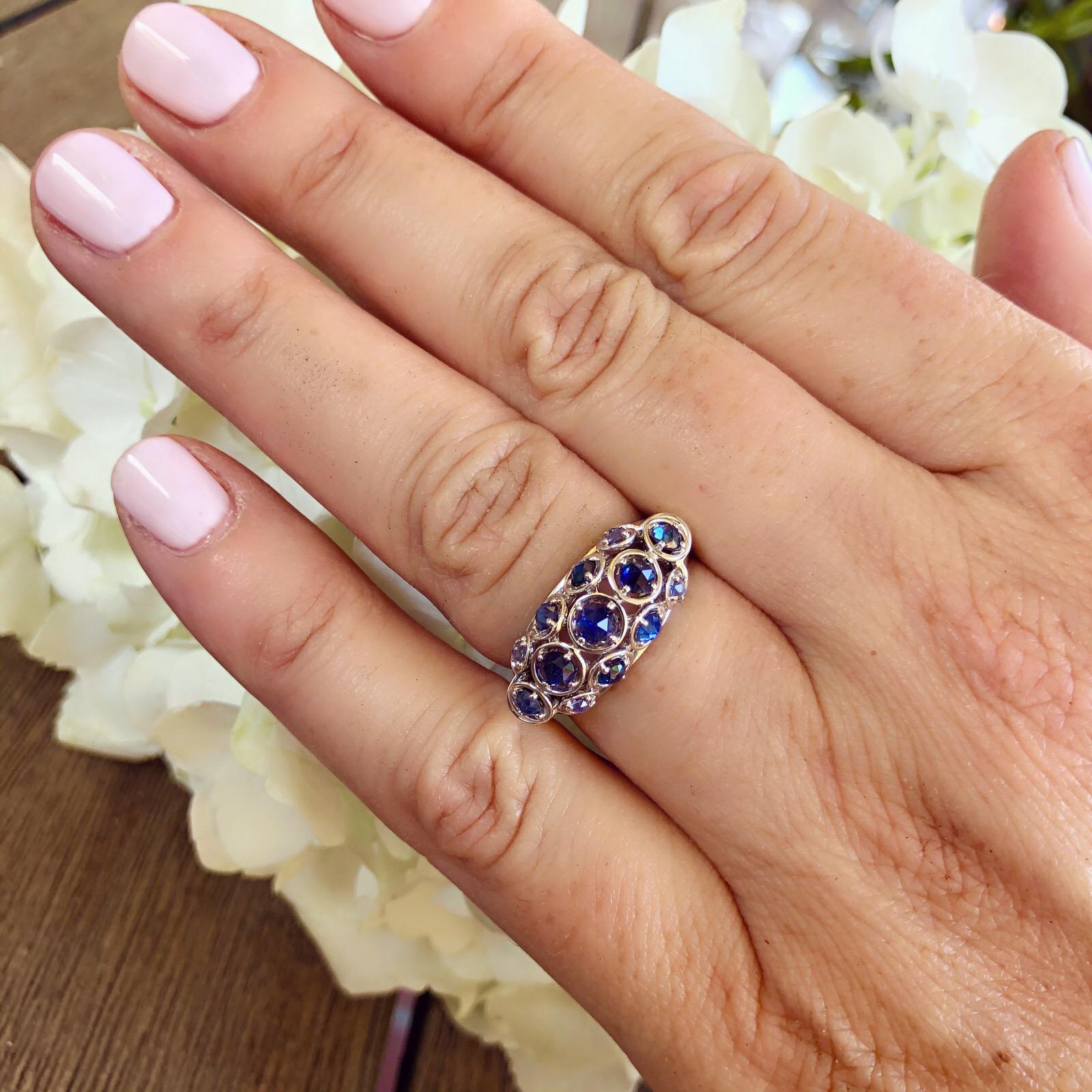 This unique 18k gold ring by famed designed Marina B. of the one and only Bulgari family, is a true find! The open domed design is set with 13 rose-cut multi-hued blue sapphires weighing 1.04 carats, weighs 5.5 grams, and is currently size 6.5 (with