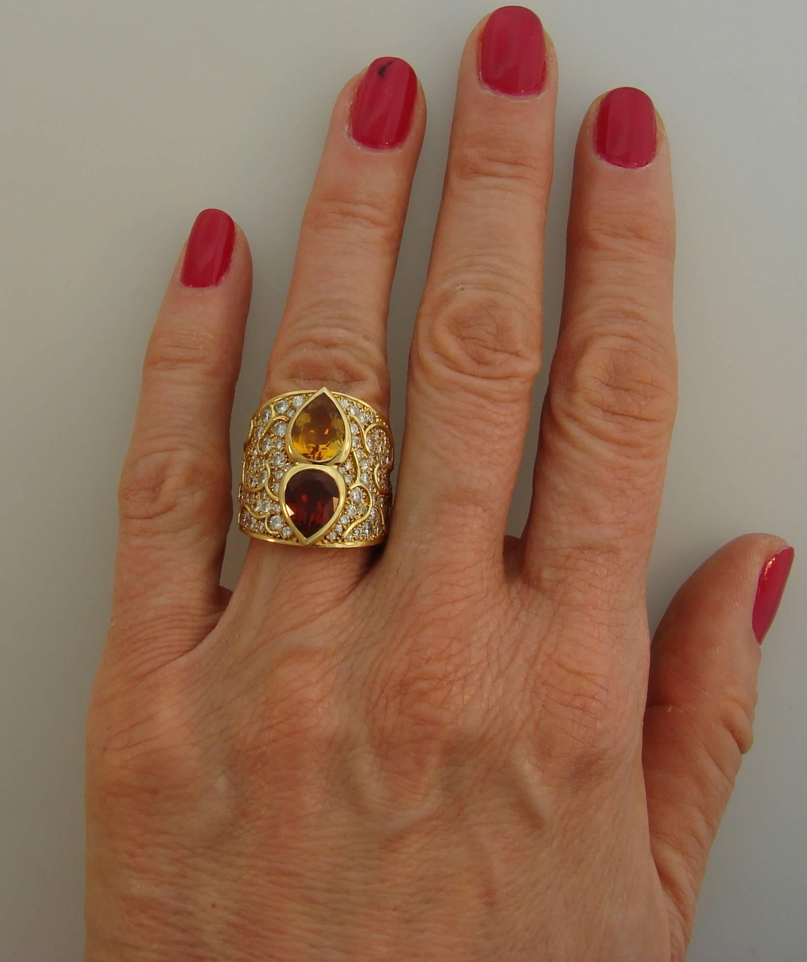 Colorful and chic cocktail ring created by Marina B in France in 1985. Made of 18 karat yellow gold, the ring features a pear-shape topaz and citrine accented with a hundred and two round brilliant cut diamonds (G color, VS1 clarity, total weight