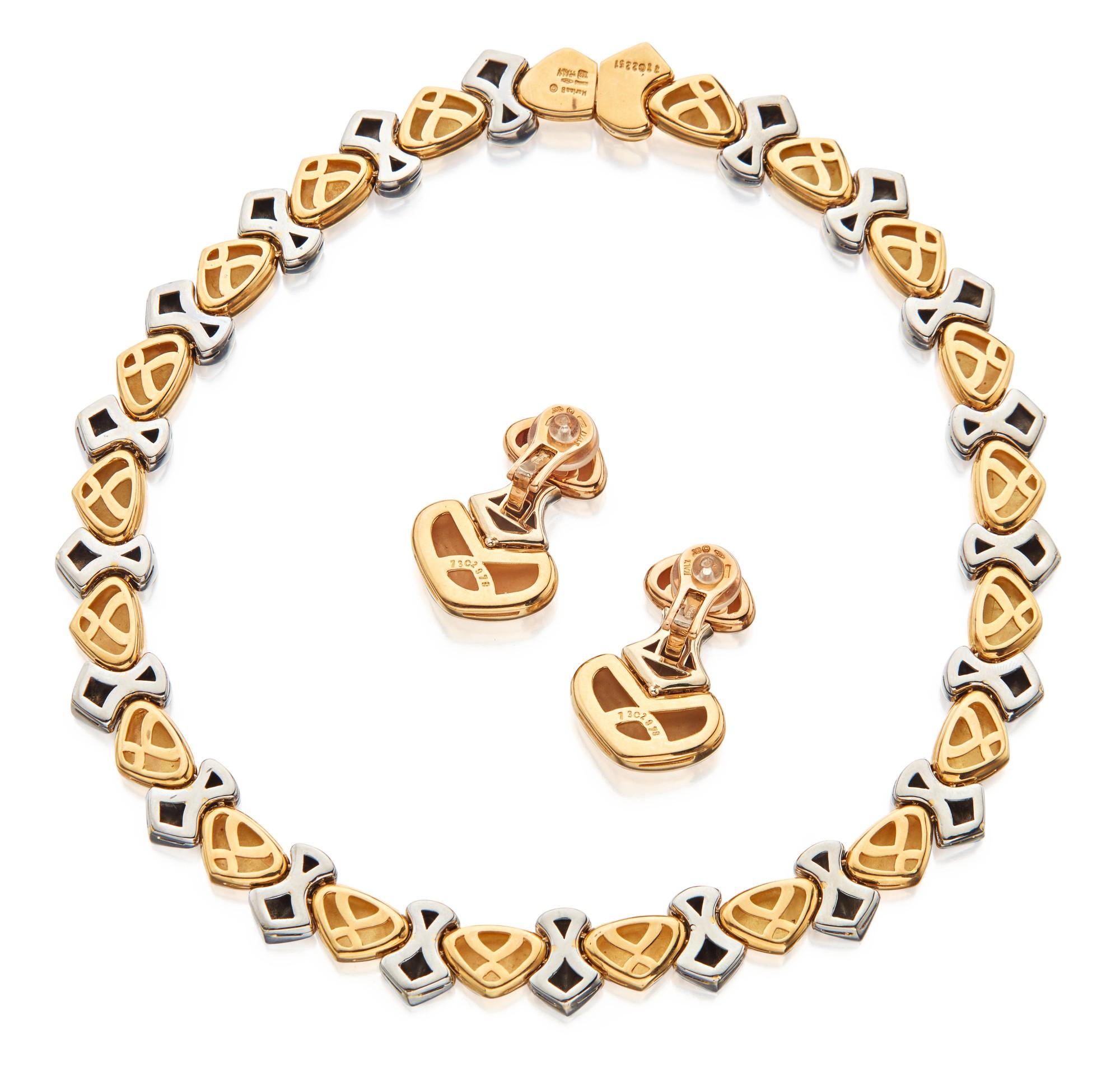 A stylish demi-parure by Marina B featuring stylized heart and shield-shaped links in yellow and white 18 karat gold. Necklace length 14¼ inches; earclip length 1⅜ inches. Made in Italy.