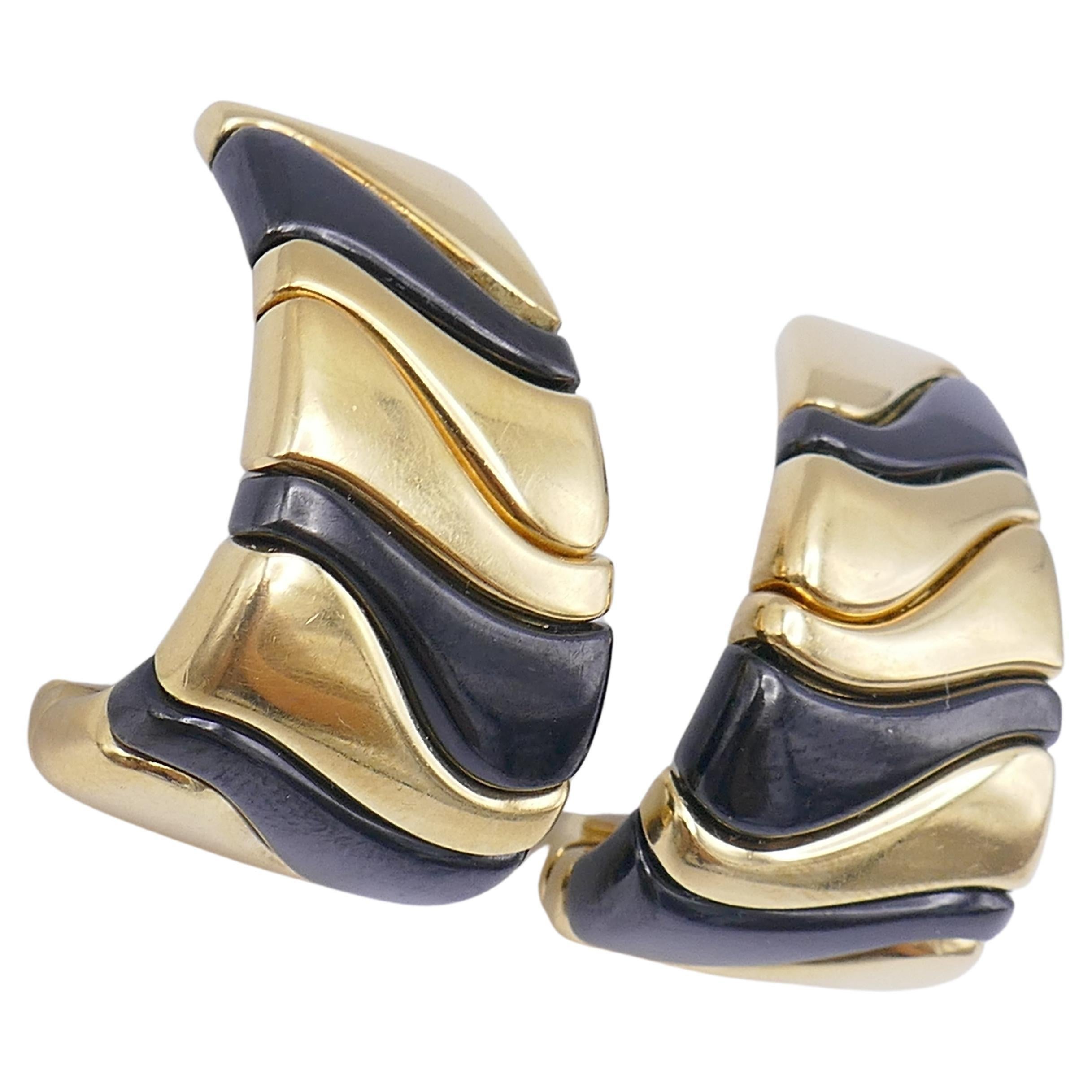 A pair of a statement earrings by Marina B, from 1987 (stamped) . Made of 18k yellow gold, onyx and stainless steel. Stamped with Marina B maker's mark, a hallmark for 18k gold, a country of production (Italy) and a serial number. 
Measurements: 1