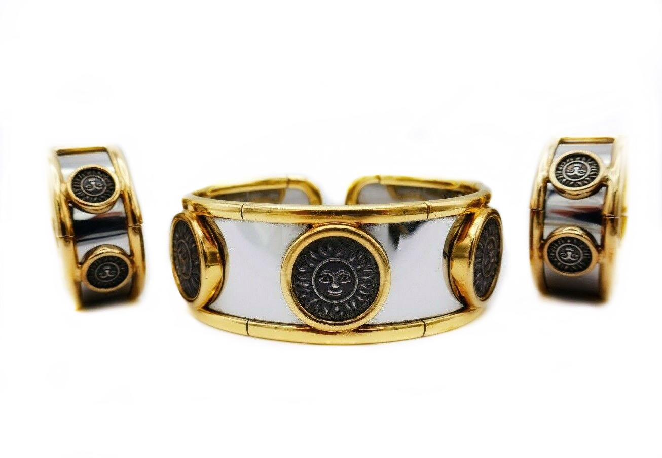 A gorgeous vintage set by Marina B from Soleil collection. Features a cuff bracelet and ear clips. Made of stainless steel and yellow gold; the suns are silver. Stamped with Marina B maker's mark, a serial number, a hallmark for 18k gold and a year