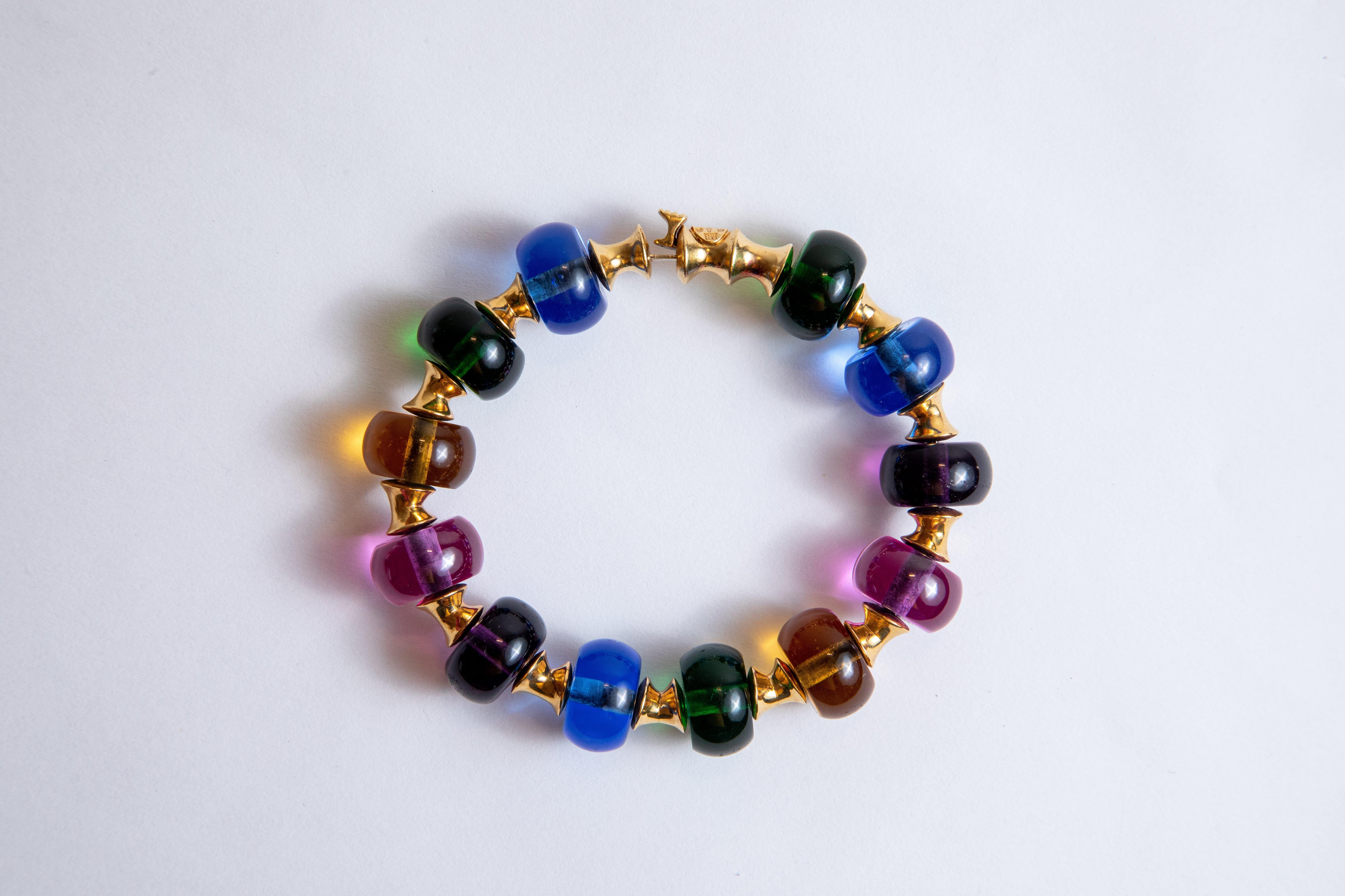Bracelet made of multicolored glass paste spheres, interspersed with diabolo motifs in 18k yellow gold

Signed Marina B.
