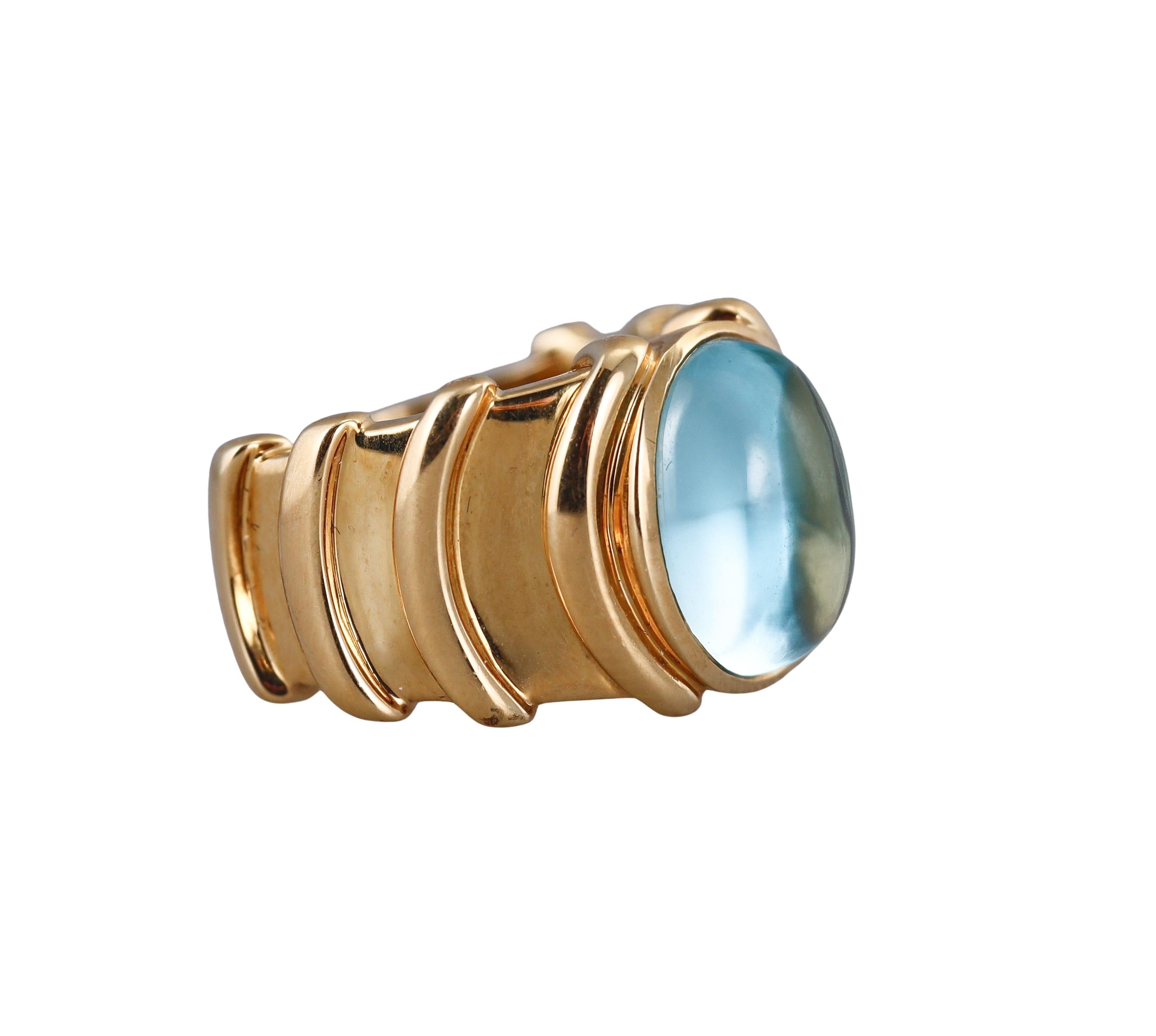 An 18k yellow gold open back ring by Marina B, with oval 13.5 x 10mm blue topaz. 
Ring size 7, top is 15mm wide.
Marked: Marina B, 750, 119012.
Weight - 19.6 grams.
