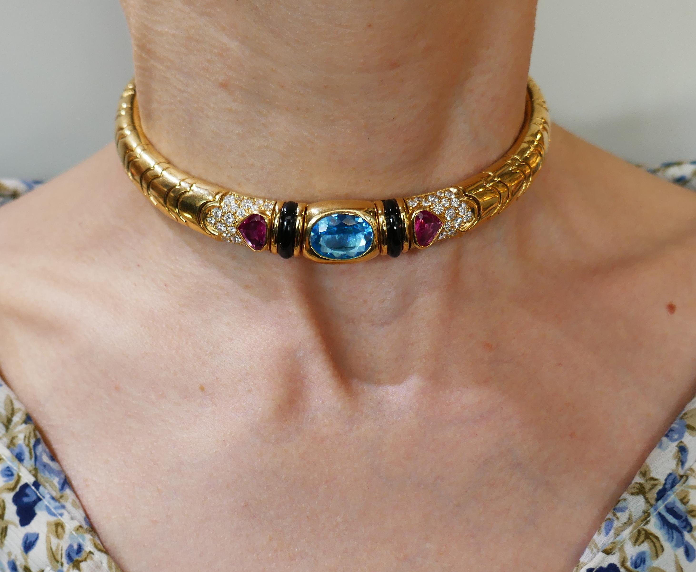 Colorful and chic choker necklace created by Marina B in 1980s. It definitely makes a statement! Elegant and wearable, the choker is a great addition to your jewelry collection. Features a faceted oval-shape blue topaz set in 18 karat yellow gold