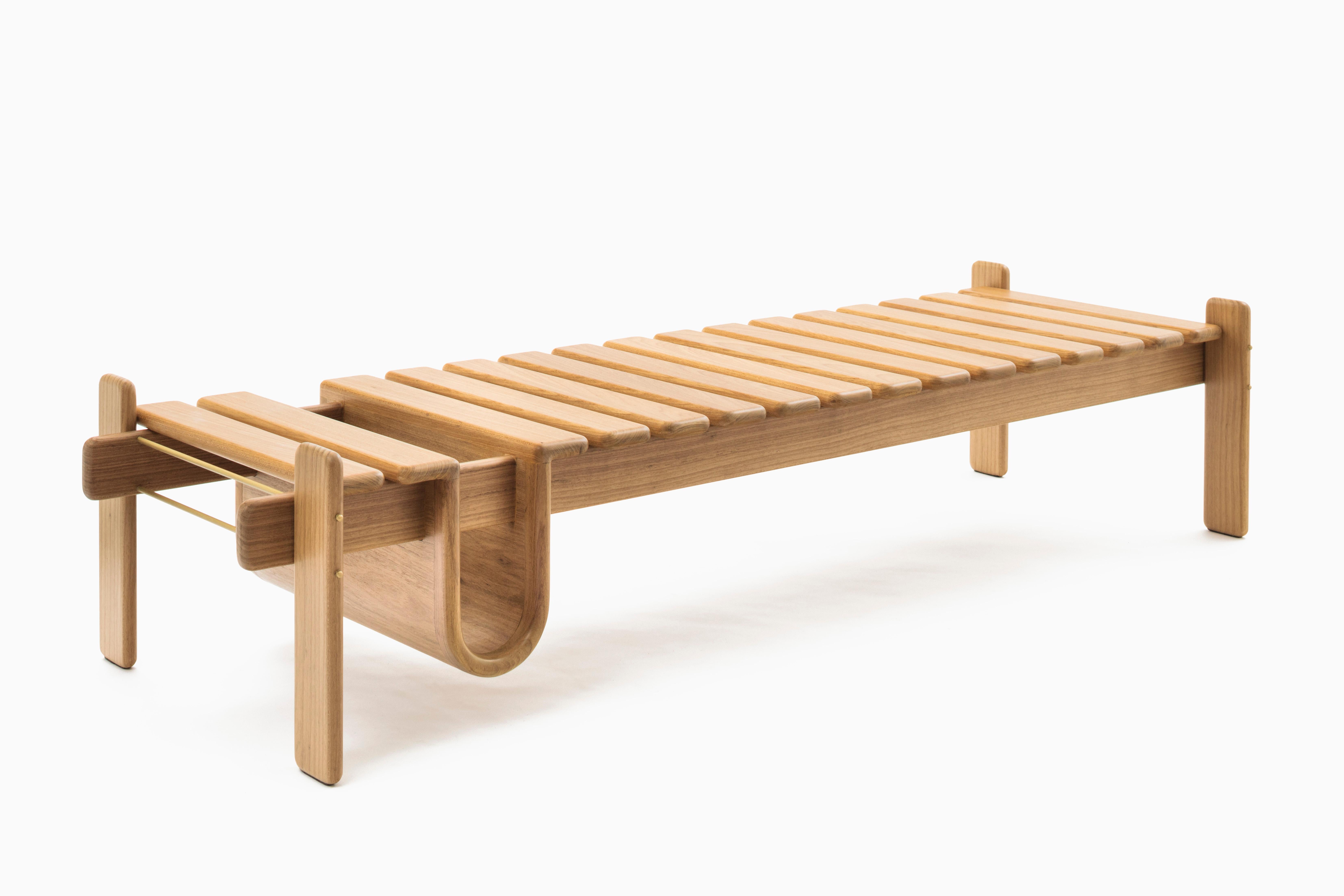 Wooden modular slats overlapping and a sculpted pouch that gives movement to the piece.
