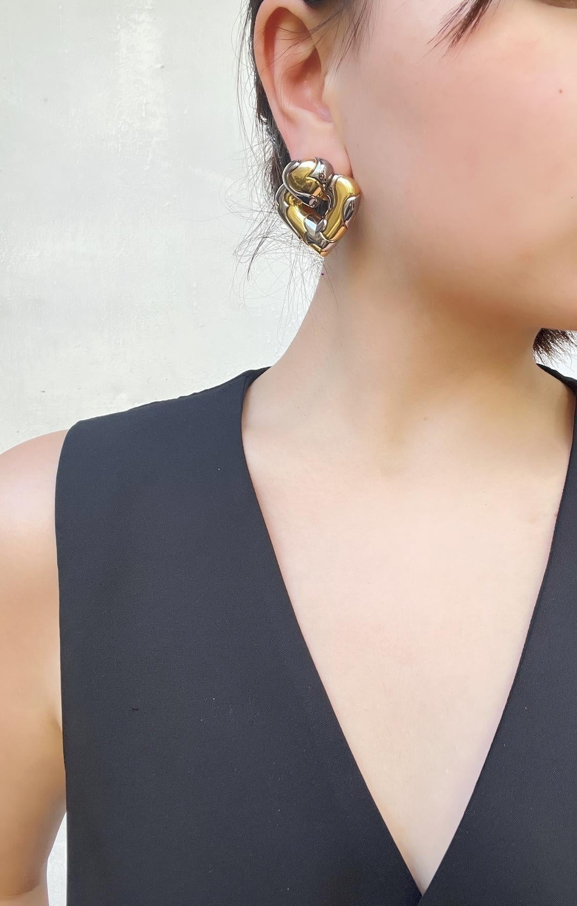 1987's Marina Bulgari 18K Gold & Sterling Silver Heart Earring

18K Gold & Sterling Silver - Stamped on back of ear clips.

Approximate Dimensions:
3.7 cm (Length) 
3.7 cm (Width)
45.8 grams in weight.
