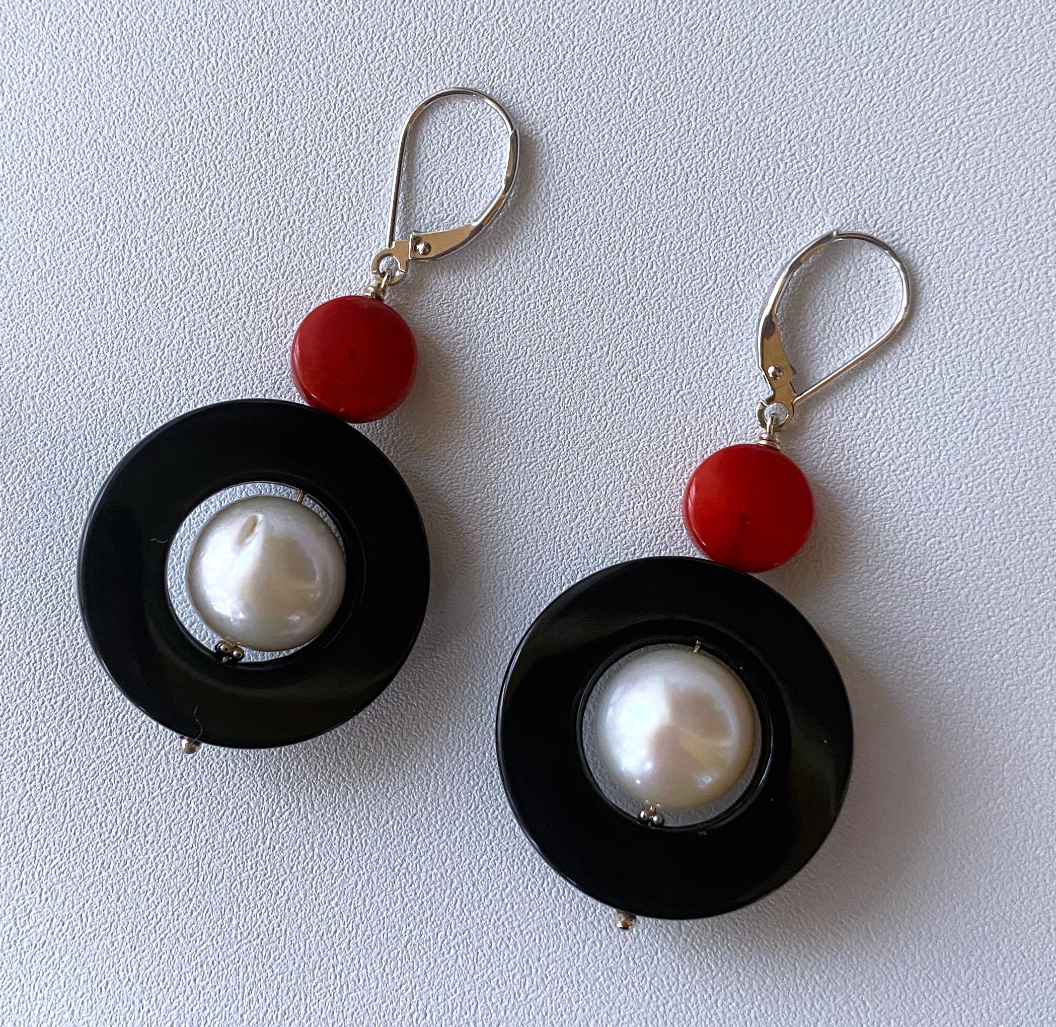 Beautiful pair of Cocktail Earrings by Marina J. These earrings feature a high shine and luster white Pearl with a magnificent iridescence, hanging within a flat Black Onyx Donut Bead. The stark contrast of Black and White is further complimented