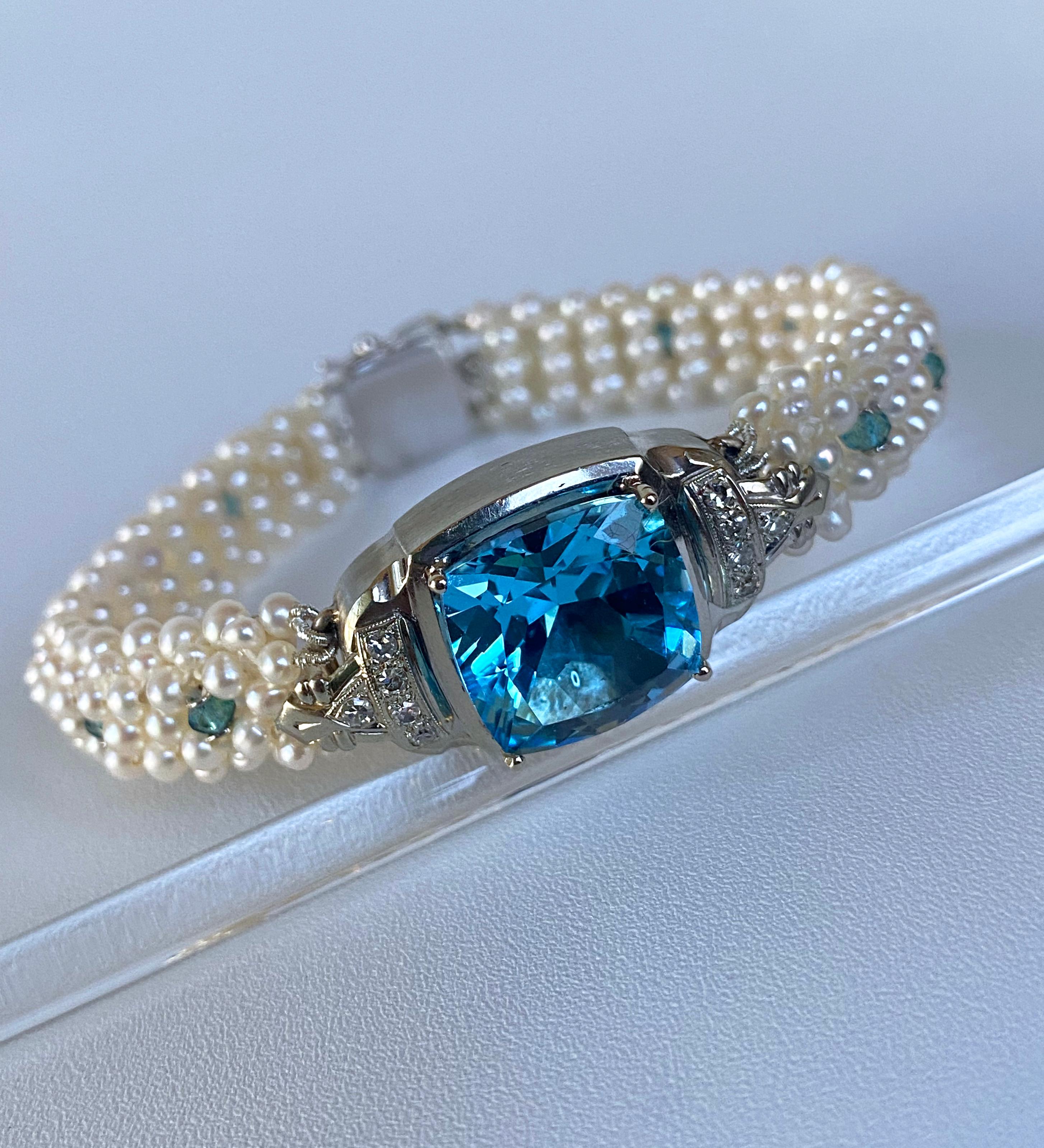 Classic One of A Kind piece by Marina J. This bracelet features a gorgeous Antique solid 18k White Gold - Diamond encrusted watch which has been reworked. A stunning London Blue Topaz has been set in the middle, radiating brilliant flashes of bright