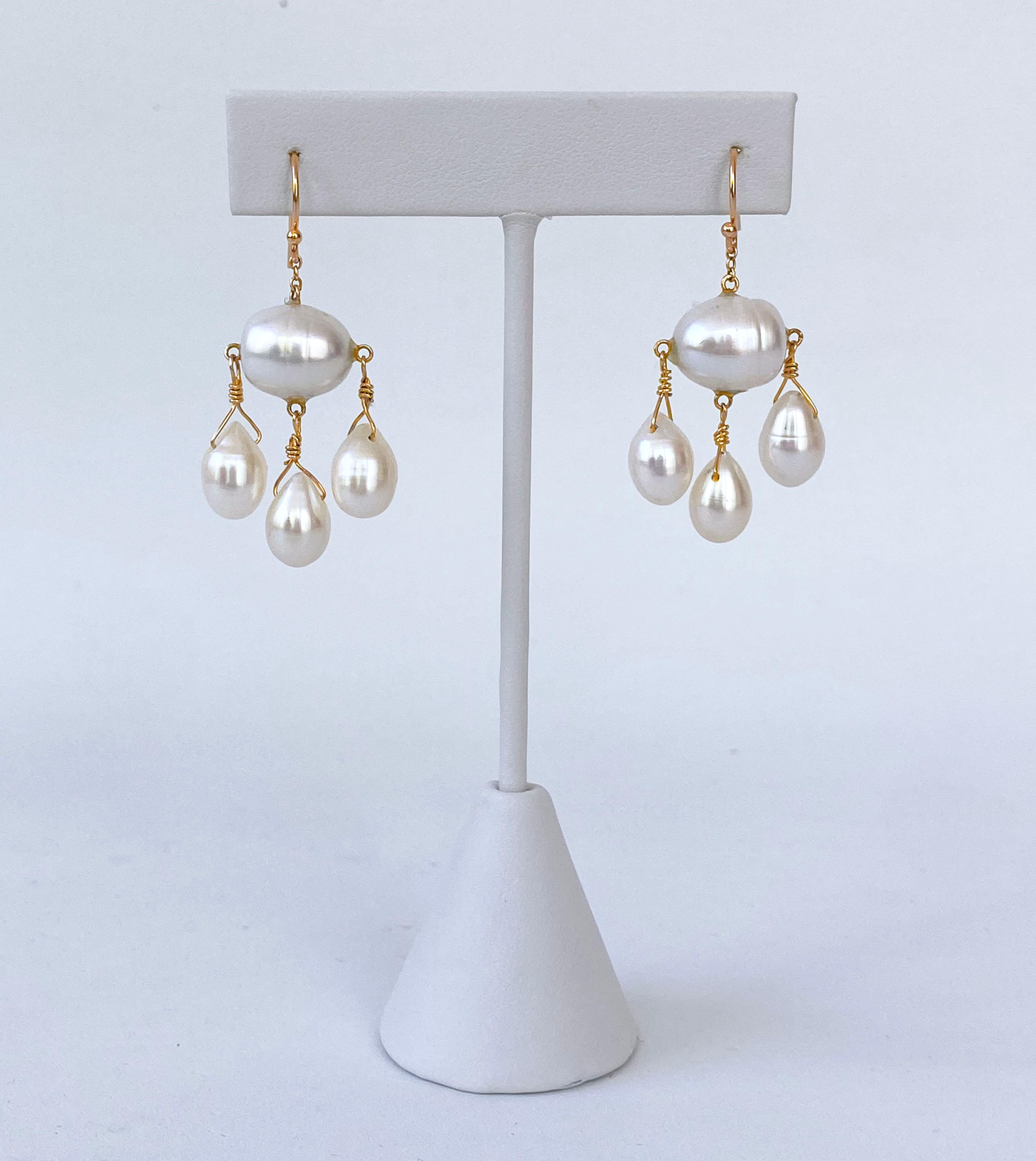 Stunning pair of Earrings by Marina J. This pair is made with all solid 14k Yellow Gold wiring and hooks. A Baroque Pearl with a beautiful iridescent luster sits as three Teardrop Pearls hang from it. The Pearls all display a soft sheen that is