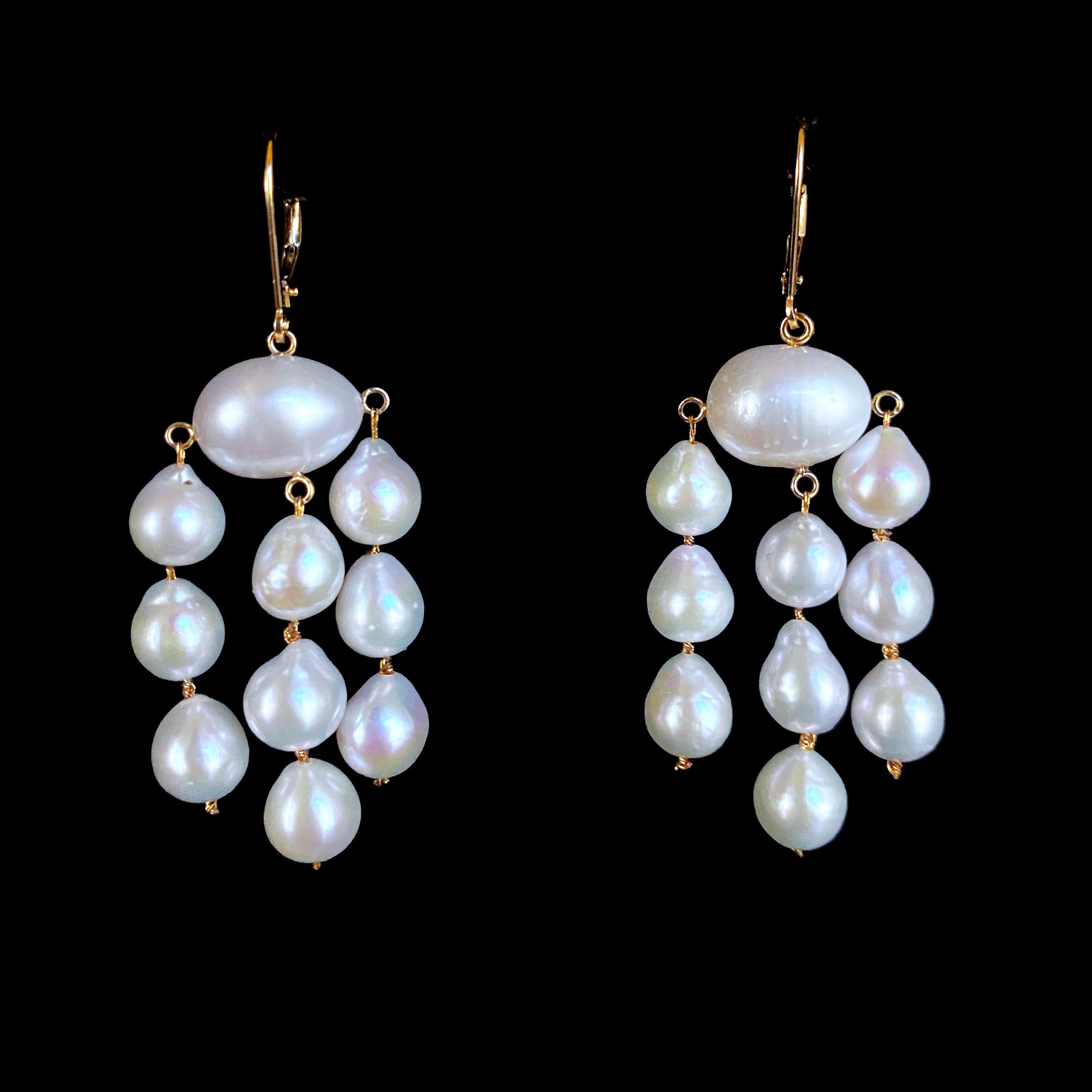 Simple and stunning pair of Earrings by Marina J. This pair is made of all solid 14k Yellow Gold wiring and hooks. A oval Baroque white Pearl sits in the middle, from which three strands of 3 Teardrop shaped Baroque Pearls hang. The Pearls in this