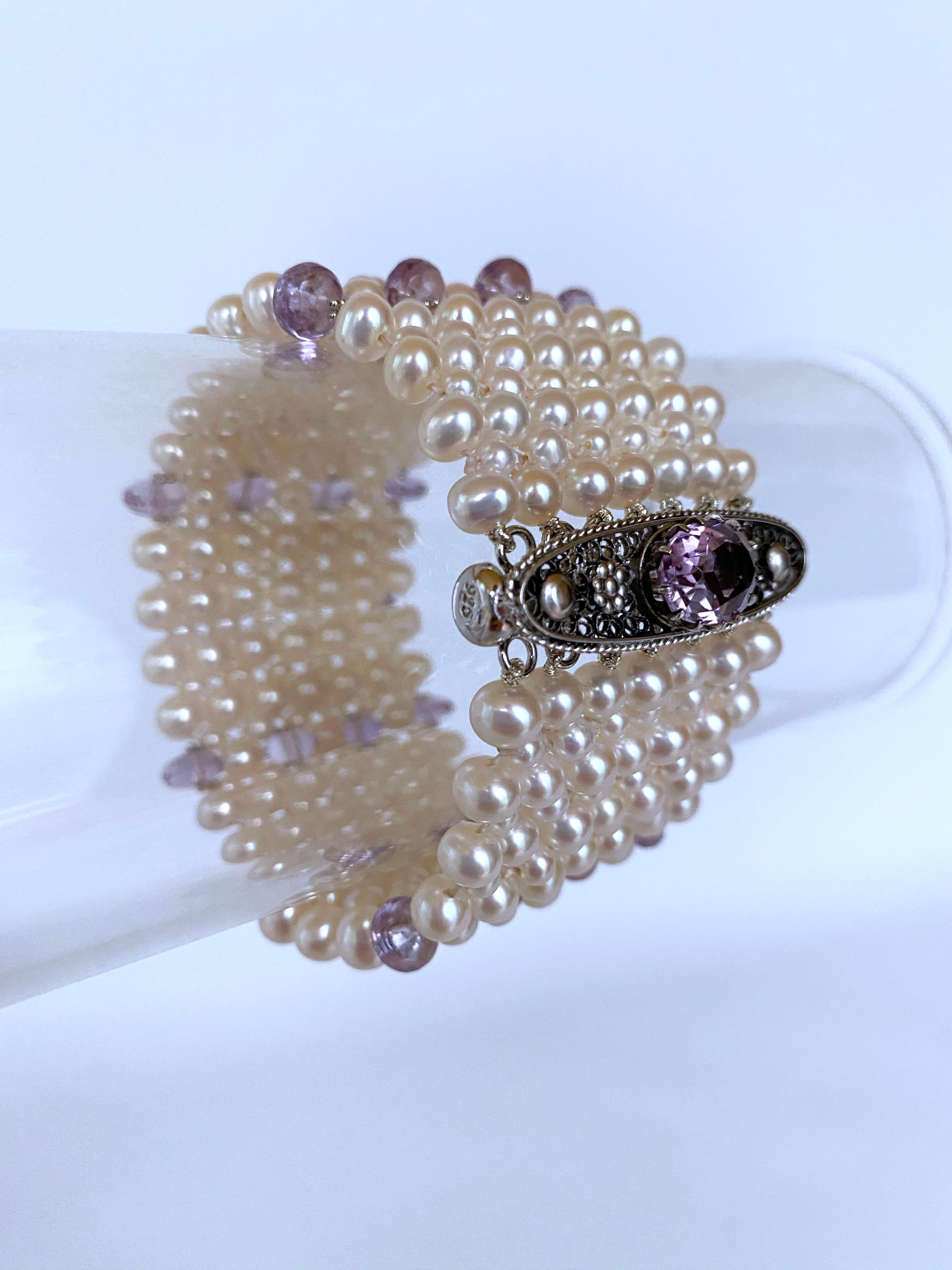 Gorgeous piece from Marina J. This intricately hand woven bracelet is made of high luster cream Pearls which display a wild iridescence of soft color. The multi sized pearls (2.5mm and 4mm)  are woven into a lace like pattern and complimented by