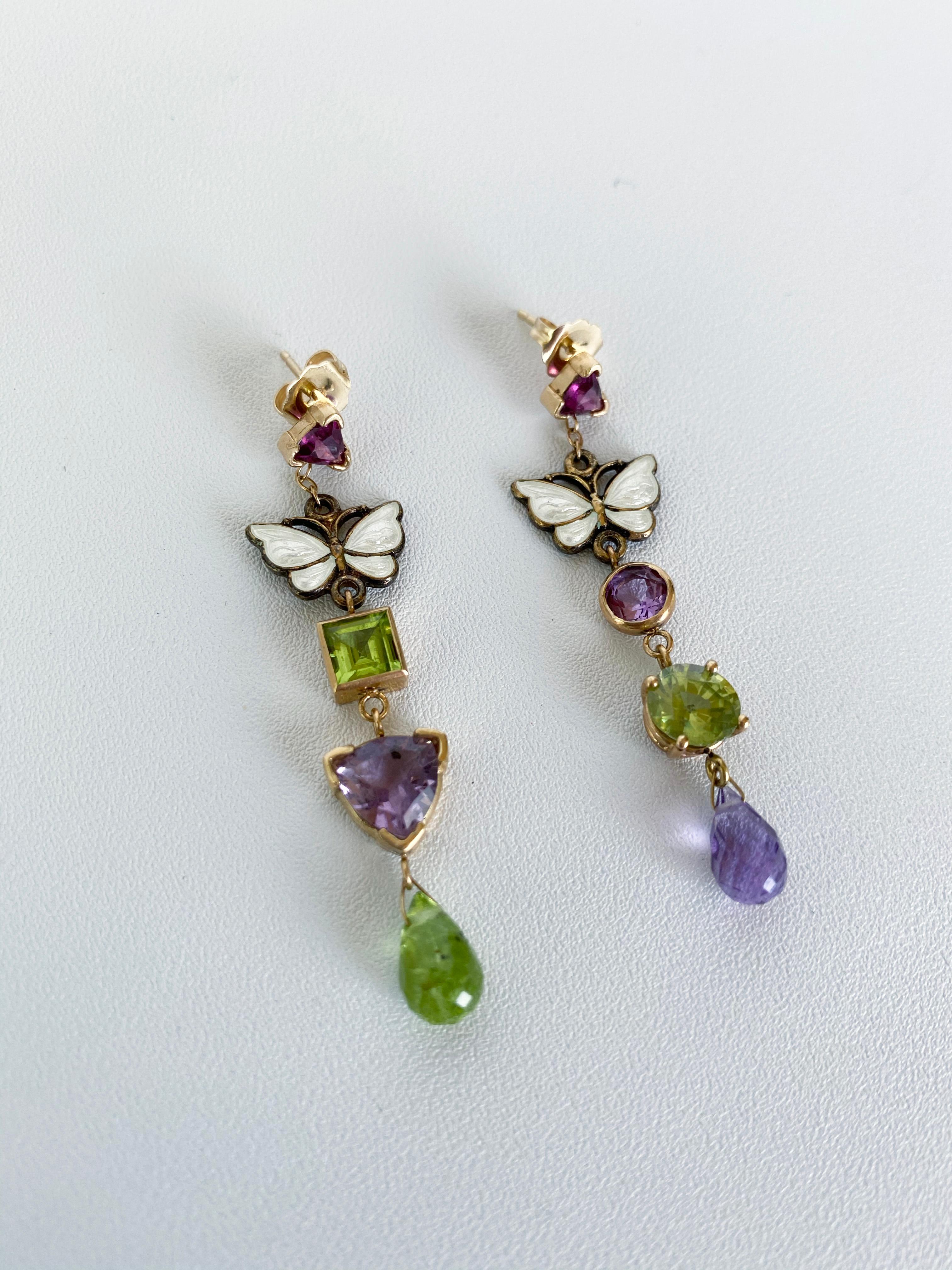 These beautiful colorful earrings feature vintage enamel butterflies over Sterling Silver. Adorned in Garnet, Amethyst and Peridot stones set multi-shaped in 14k Yellow Gold. These playful and versatile earrings can be worn up or down, and are a