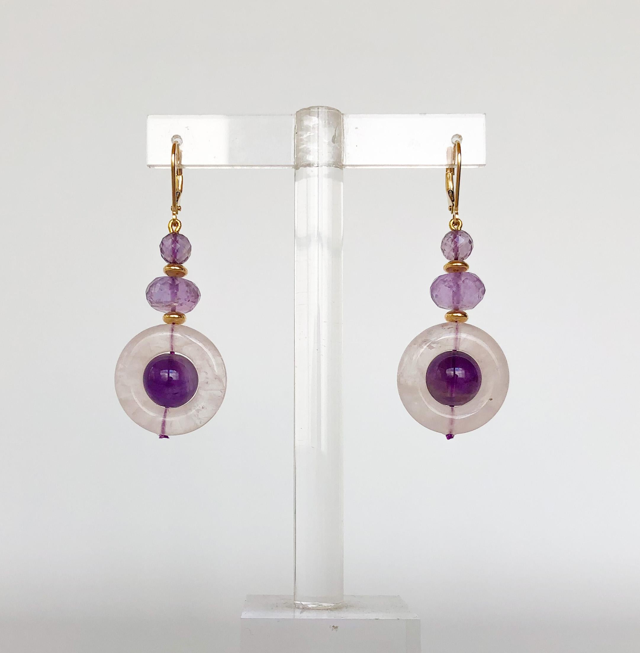 These earrings are made of amethyst beads and a rose quartz ring. There are also tiny gold beads in between the gems for a pop of color. The earrings are just about 2 inches long, and have sturdy 14k yellow gold lever-backs. This piece is part of