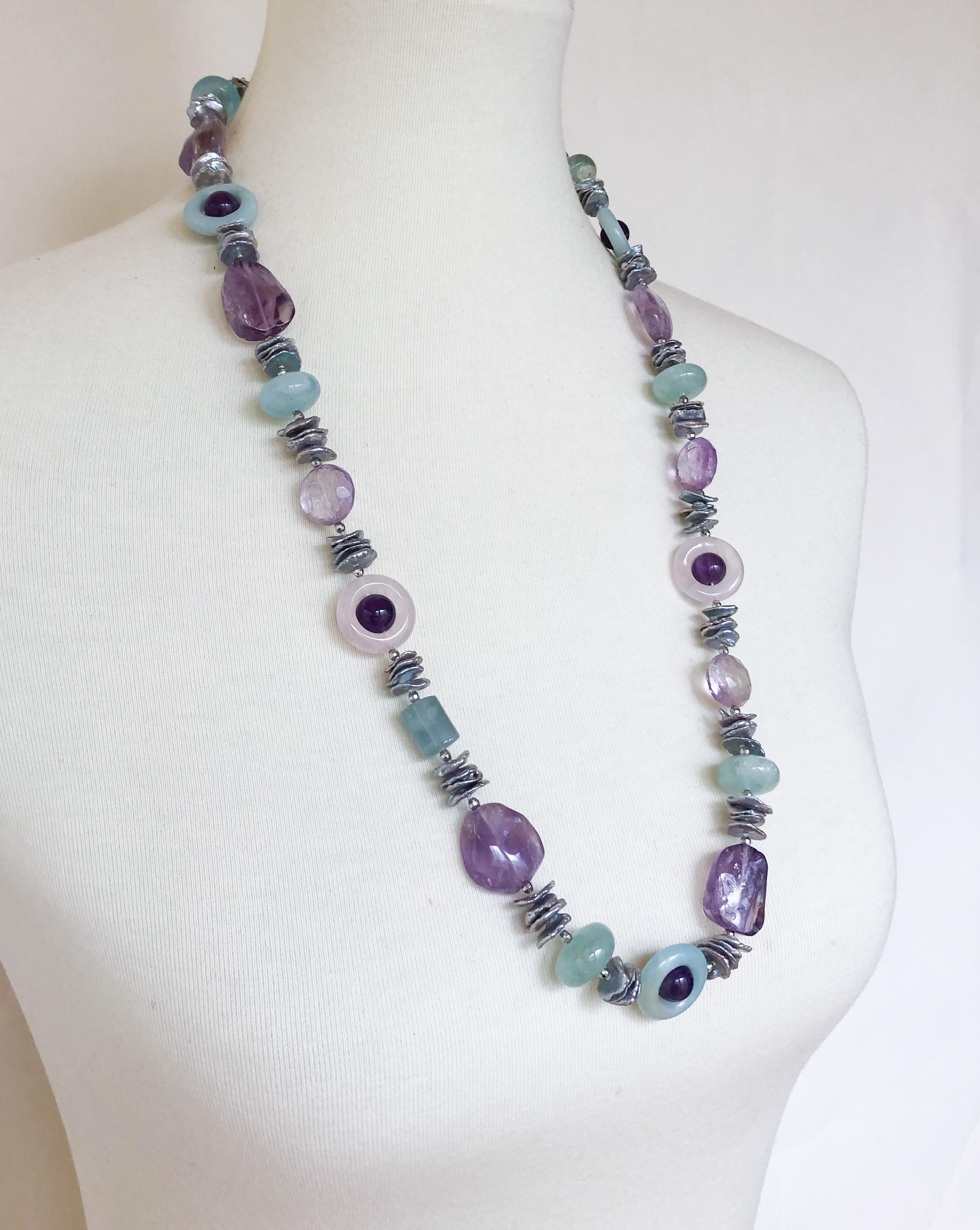 Gorgeous stone necklace by Marina J. This lovely piece is made using multi shaped faceted Amethysts, Rose Quartz, Aquamarine, Amazenite and Freshwater irregular shaped Grey Pearls which display a vivid iridescent sheen. Due to the translucent nature