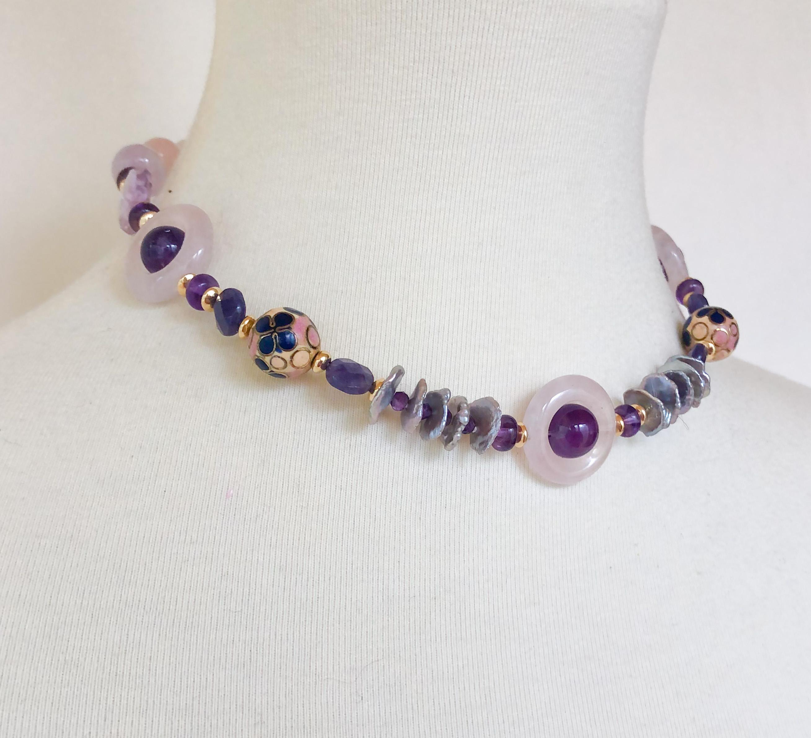 This necklace is made with various shapes and shades of amethyst, as well as rose quartz beads and freshwater graded grey pearls. There are two vintage enamel beads and vermeil gold beads as well. The magnetic clasp is made of vermeil gold, and is