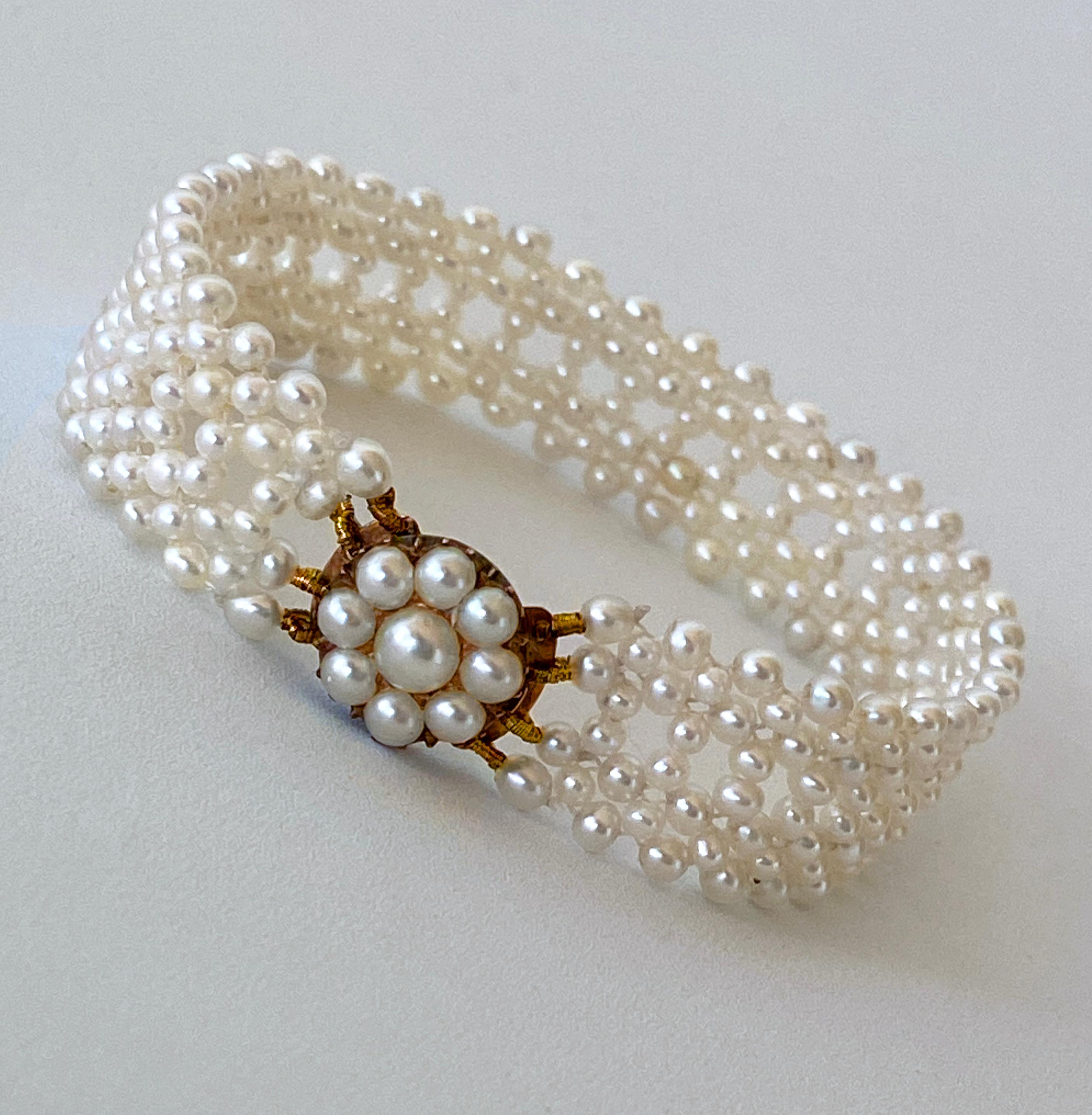 Stunning One of A Kind piece by Marina J. This bracelet features all Antique Pearls intricately woven together into a fine Lace like design. The elegance of this bracelet is heightened by the Vintage Original Pearl Centerpiece, which doubles as the