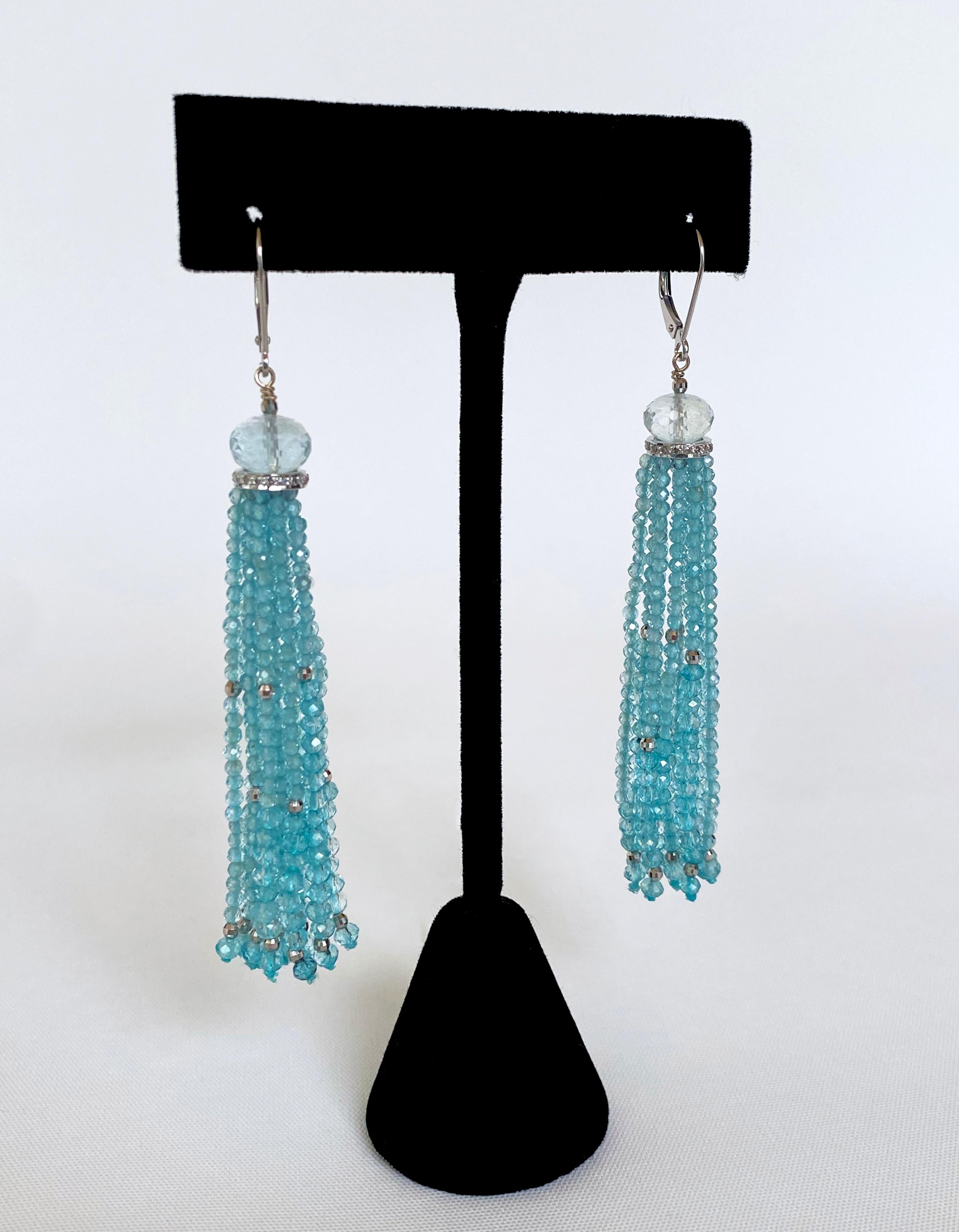 Colorfully bold Earrings by Marina J. This pair of Tassel Earrings feature faceted Aquamarine and solid 14k White Gold findings hanging from a Platinum plated Diamond encrusted Silver roundel - which a larger Aquamarine stone sits atop. The