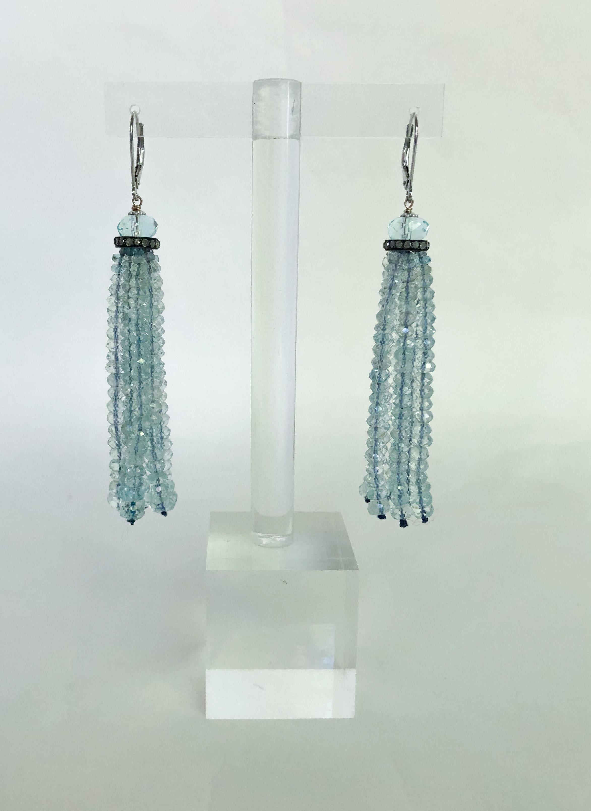 Beautiful pair of Earrings hand made by Marina J. These gorgeous Earrings feature a Faceted 8mm Aquamarine Bead, sitting atop a Diamond Encrusted roundel from which Graduated Aquamarine strands hang (2 - 4mm). The Aquamarine gives beautiful hues of