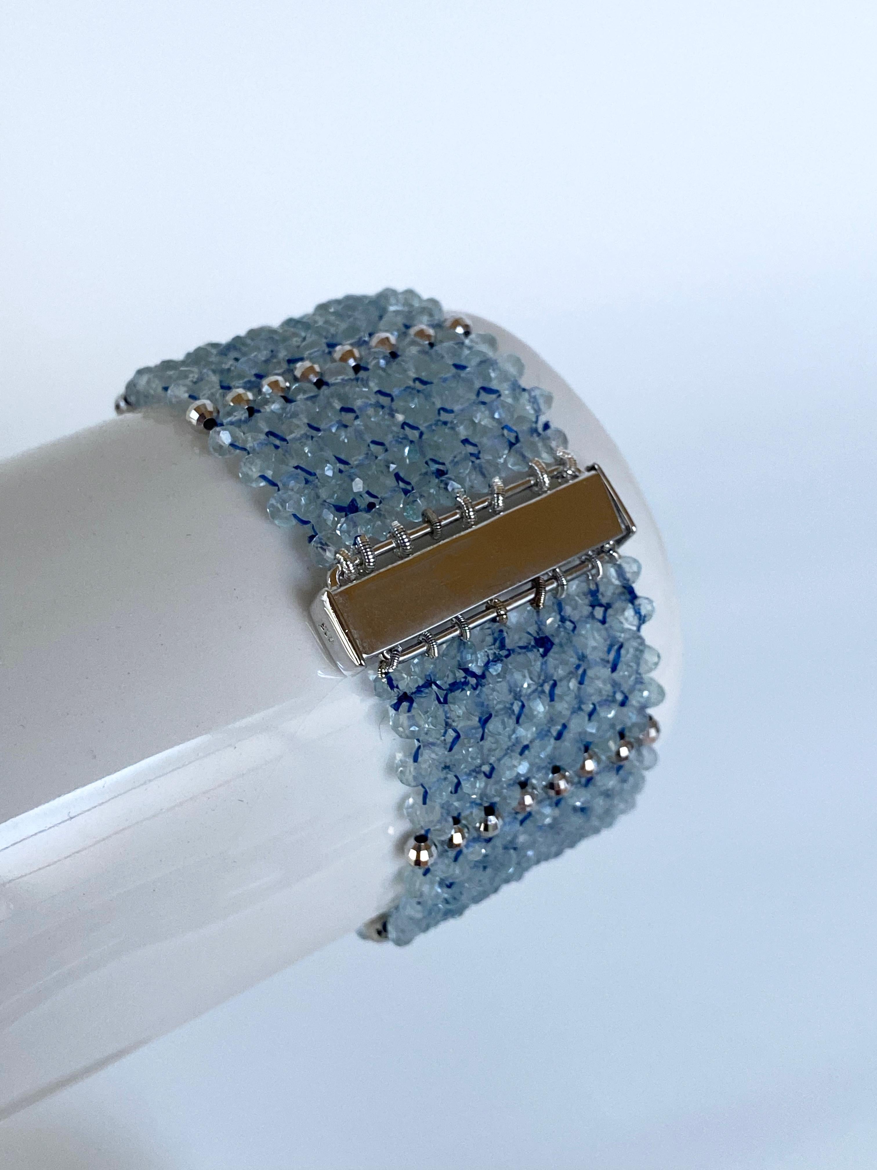Gorgeous piece by Marina J. This bracelet features faceted Aquamarine stones with wonderful baby blue Pigment, woven together with faceted Rhodium Plated Sterling Silver 'Disco