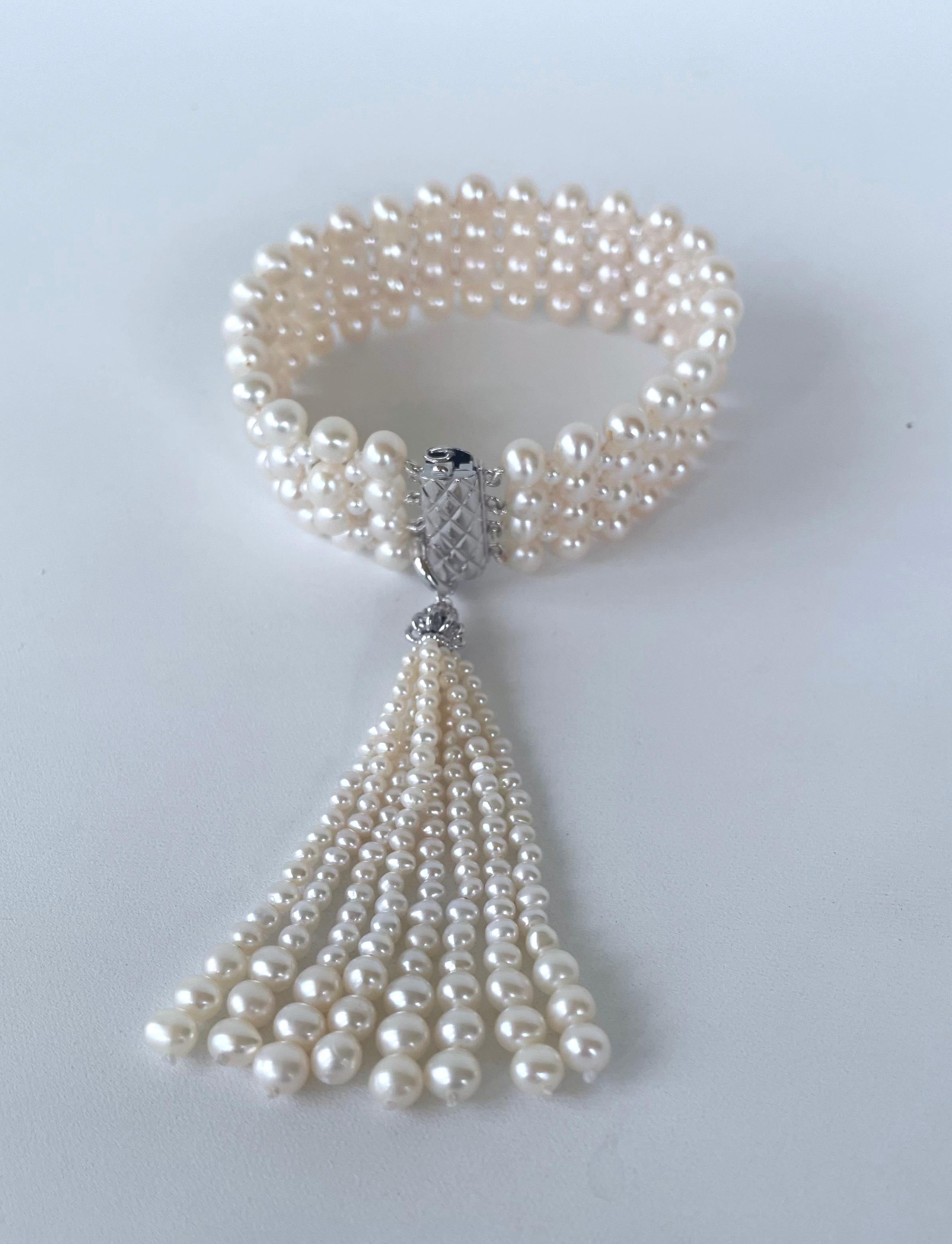 Gorgeous 1920's Art Deco Inspired bracelet by Marina J. This stunning piece features all Cultured Pearls intricately woven together into a tight lace like design. Measuring 7.5 inches long, the lace woven band meets at a decorative Silver Rhodium