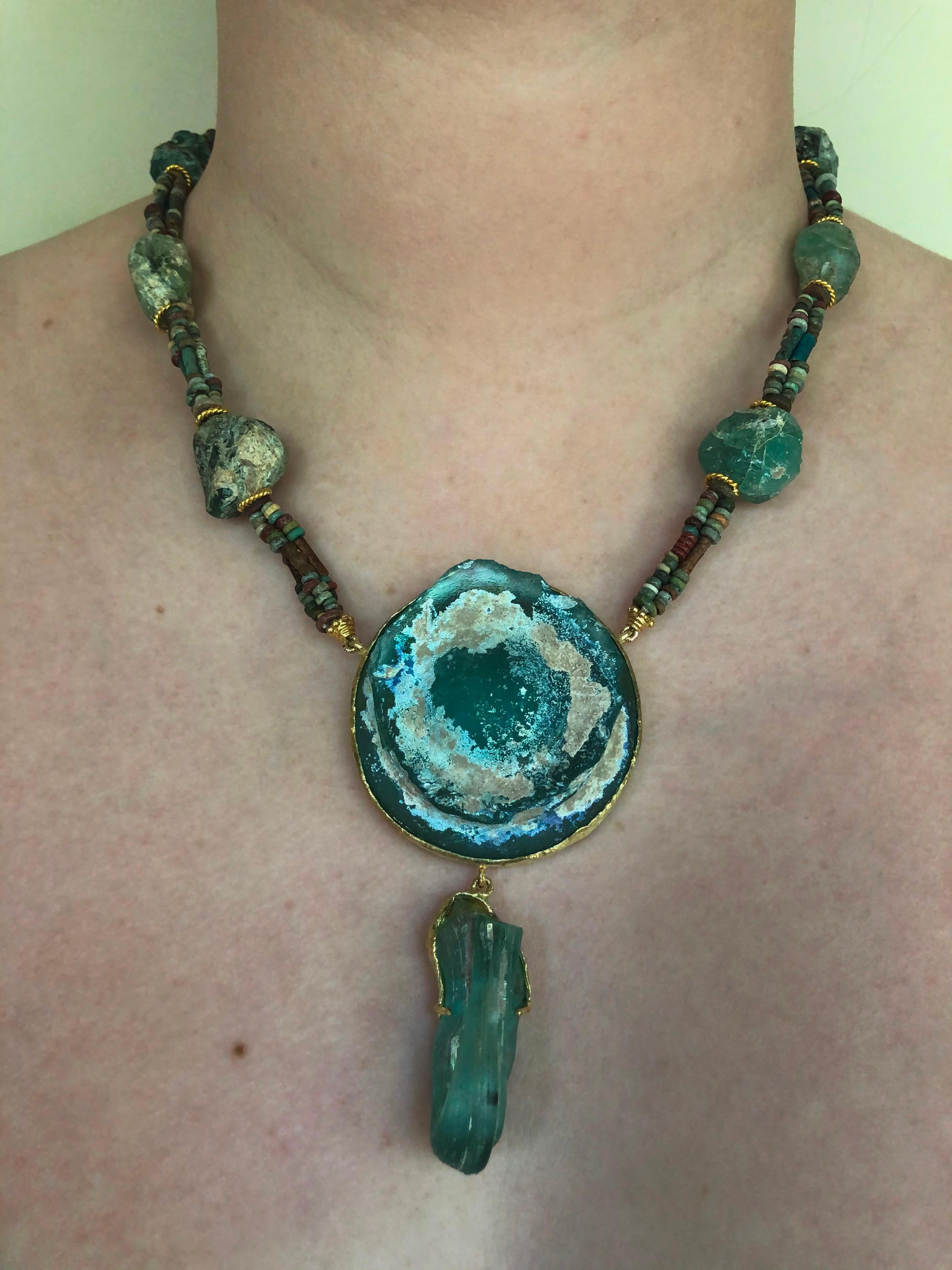 This Marina J. original necklace is made with authentic Ancient Roman glass beads, 18k yellow gold, and Egyptian Hyksos faience ceramic beads dating from 1800 BC. The larger glass beads and centerpieces are made of Ancient Roman blue-green glass,