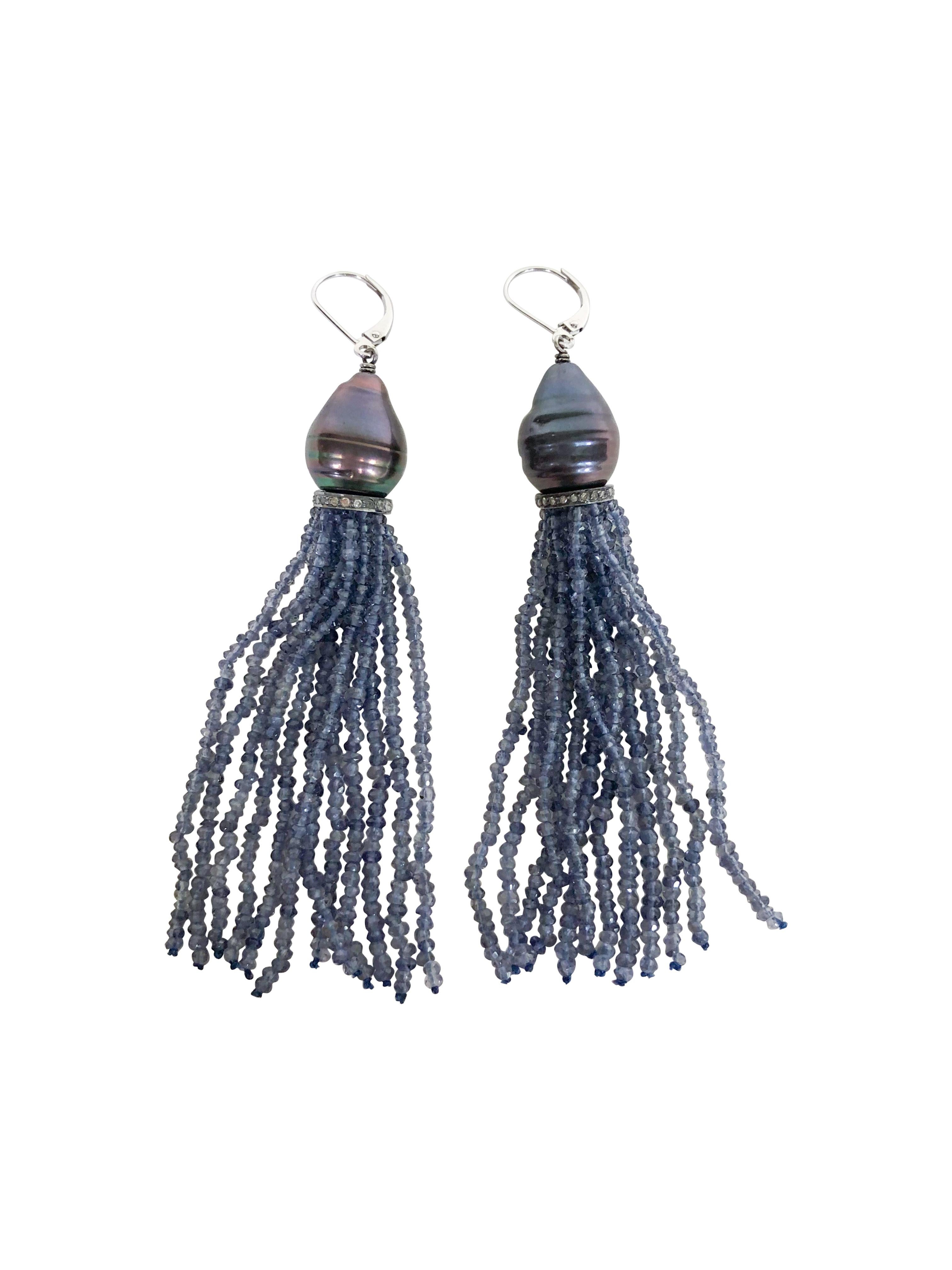 These sparkling and alluring handmade tassel earrings are made of iolite and black pearls. Faceted iolite beads hang from a large baroque black pearl and detailed with silver and diamond roundel. The faceted iolite catches the light beautifully,