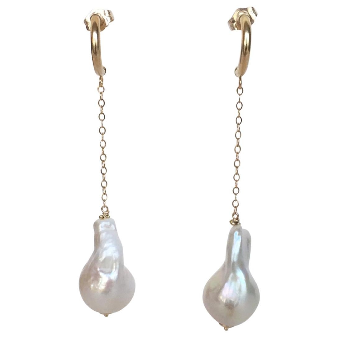 Handmade pair by Marina J. These stud earrings feature two elongated Teardrop Baroque White Pearls displaying great iridescence and luster. The Pearls hang from solid 14k Yellow Gold Chain. Measuring 2.5 inches total, both pairs have a gorgeous half