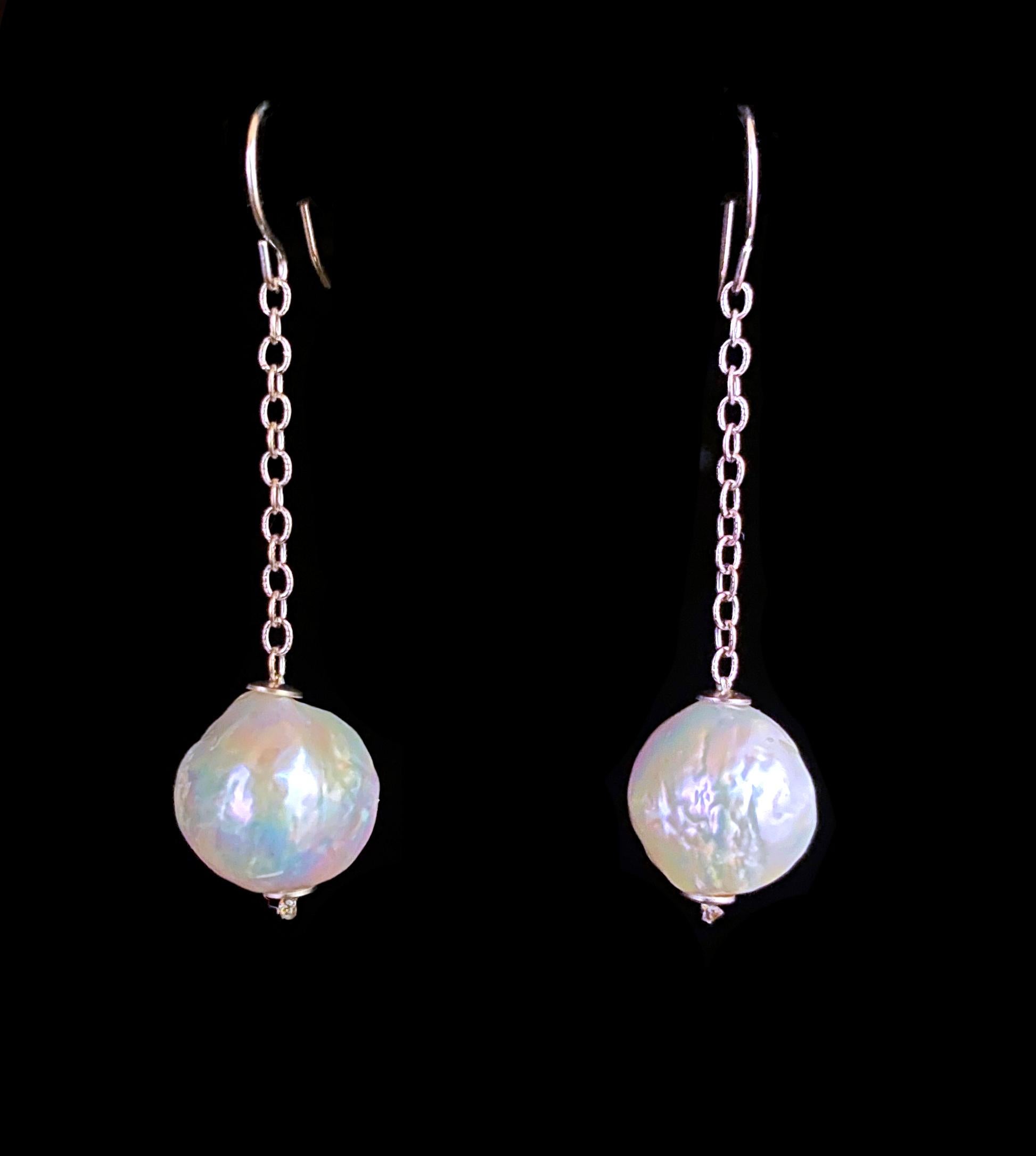 Simple and elegant pair of Earrings by Marina J. This pair of made of two cultured Baroque Pearls displaying a textured body and beautiful iridescent luster that flashes multiple colors. The Pearls are suspended between two solid 14k White Gold cups