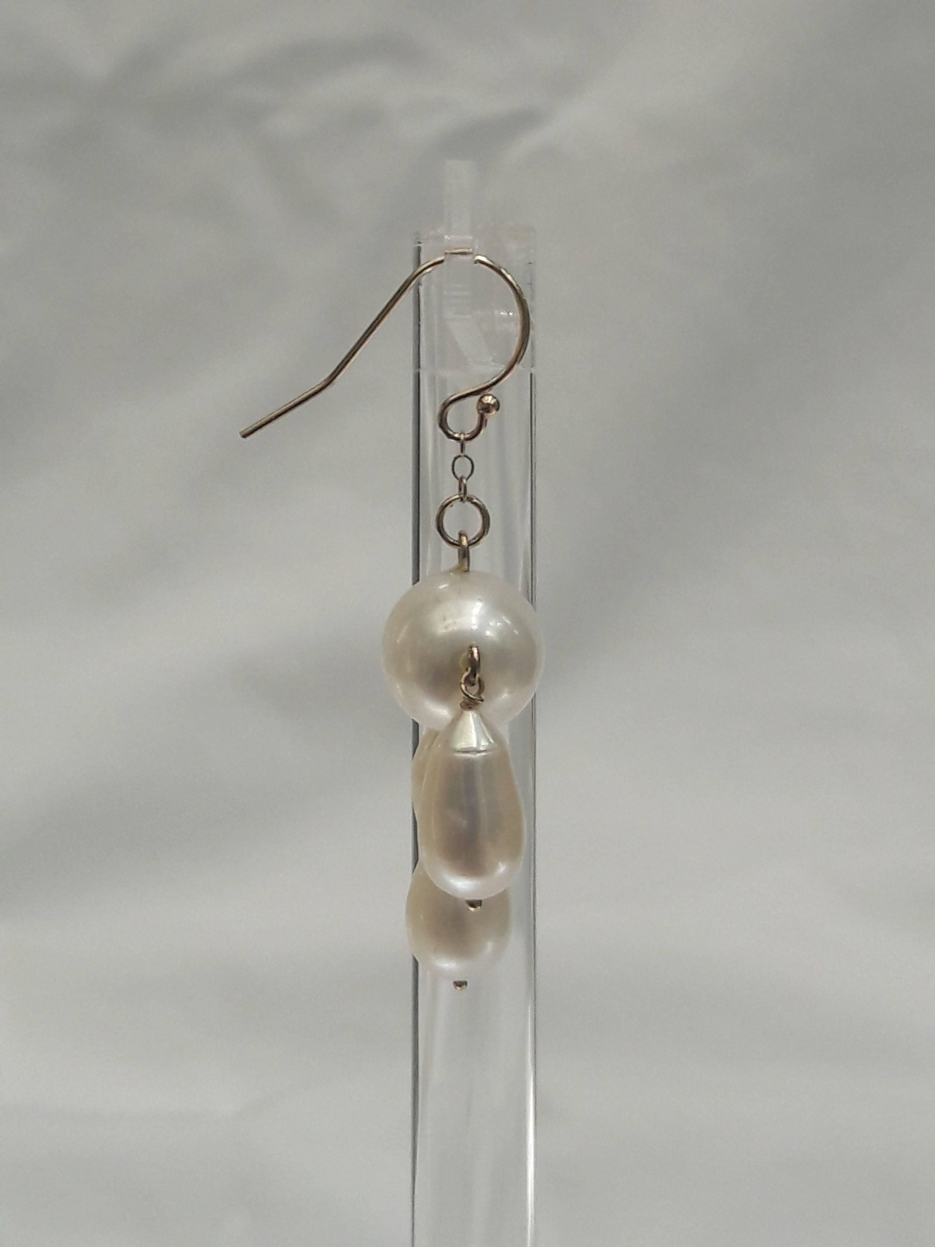 Three teardrop pearls dangle from oval shaped Baroque Pearl.

Fitted with 14 k yellow gold findings and ear wire.

Timeless and elegant. Matches any ensemble. Perfect for bridal and other formal occasions.

From top to bottom measures 1.25 inches