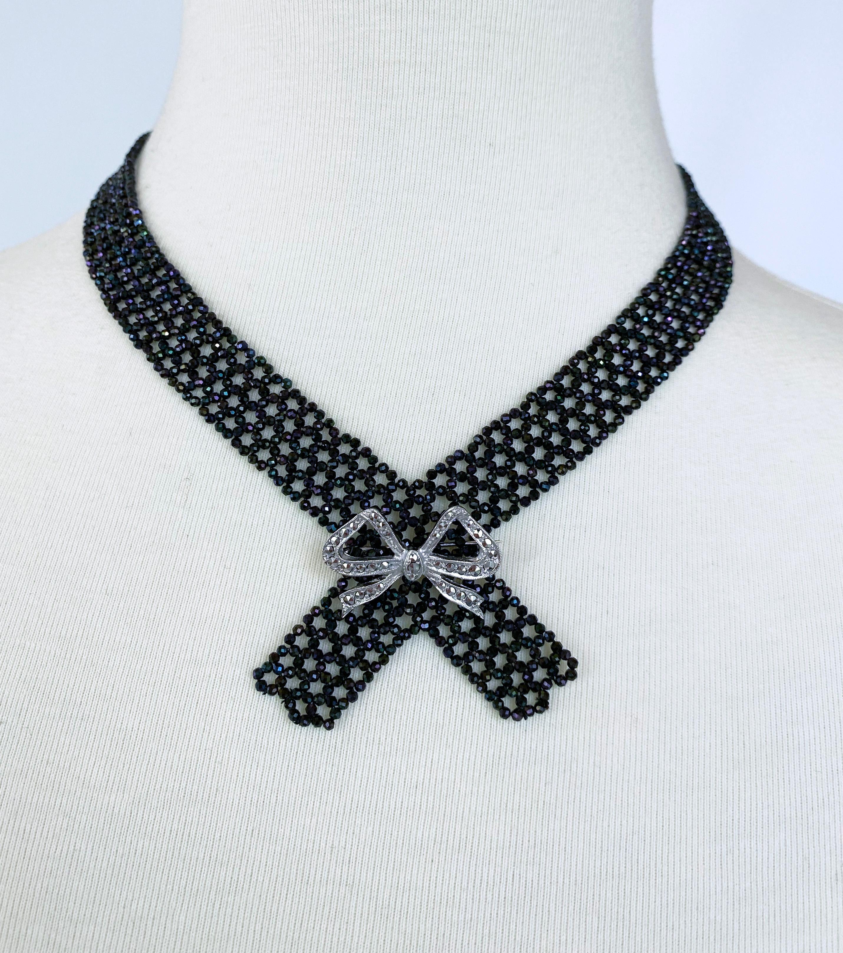  This is a black spinel collar necklace with a 14 k yellow gold clasp. The necklace shines with faceted black spinel beads woven into a lace-like pattern. The crossed weave at the center is reminiscent of the Victorian era, but the minimalist design