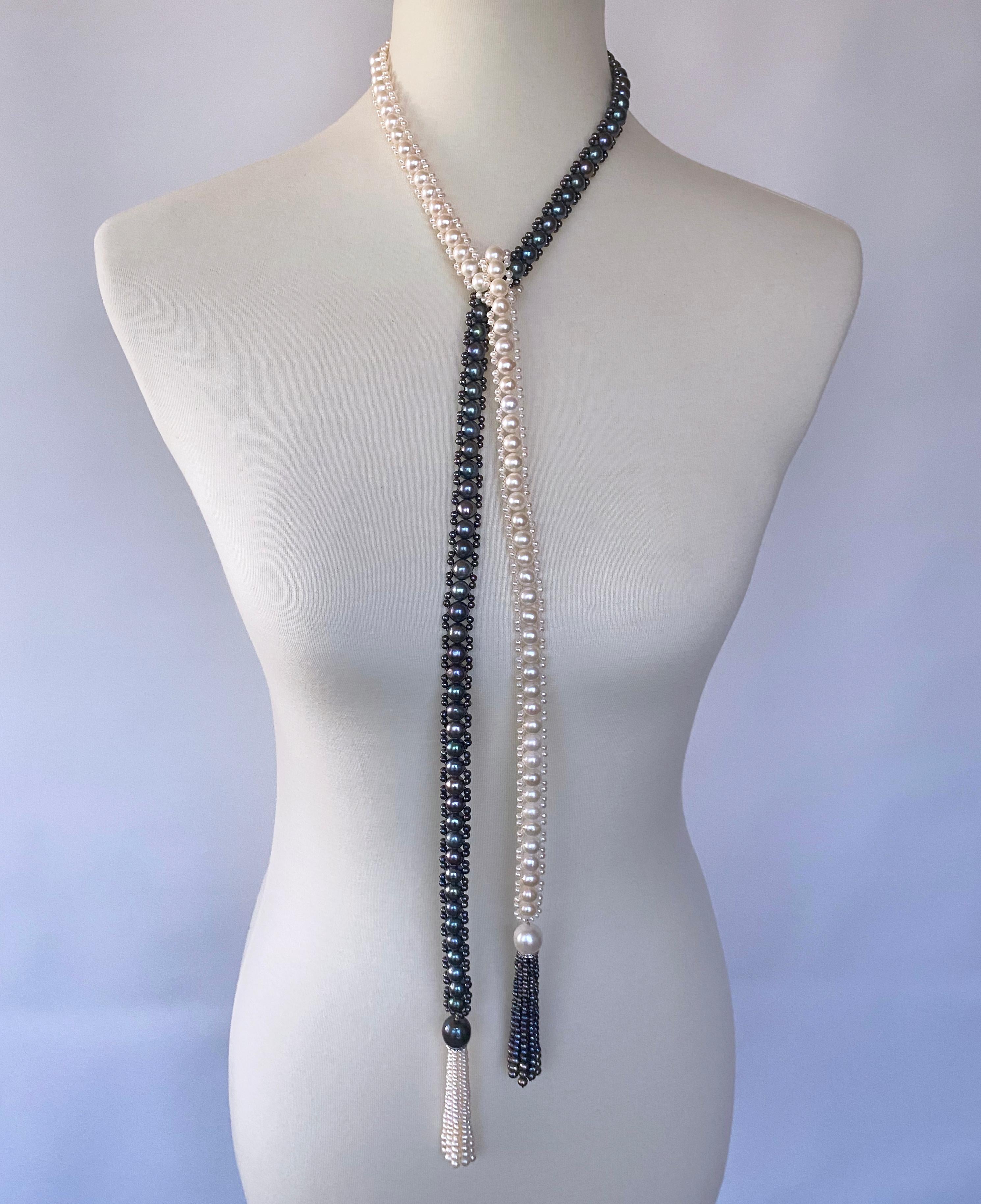 Classic Sautoir by Marina J. This stunning 'Art Deco' inspired piece is made of all cultured Black & White Pearls woven together into a lace like column. The White Pearls display a wonderful luster and the Black Pearls radiate an almost 'oil spill'