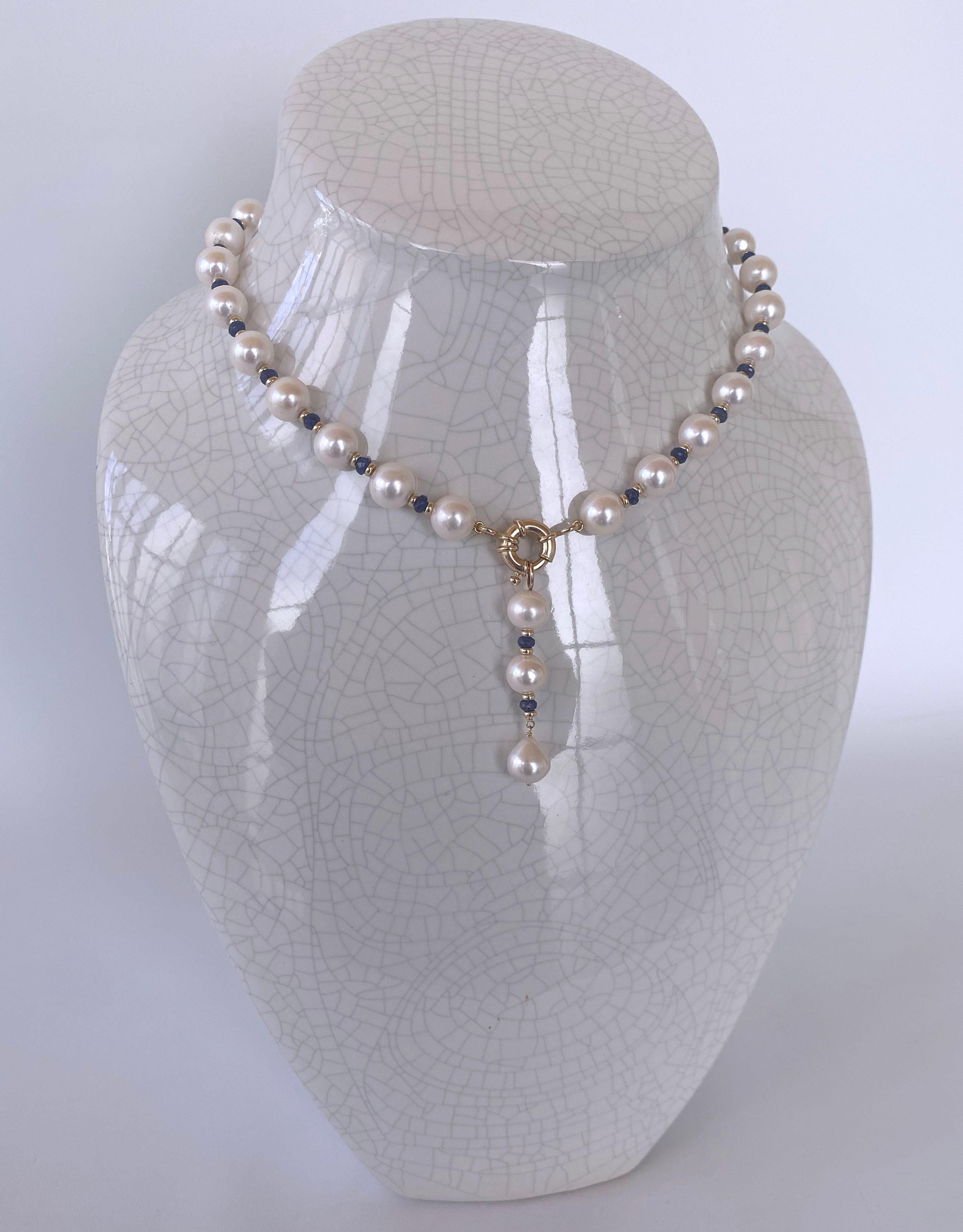Beautiful piece by Marina J. This lovely necklace features high luster white/cream colored Cultured Pearls, all wonderfully accented by faceted precious Blue Sapphire stones. The faceted Sapphires are held in between 14k Yellow Gold findings which