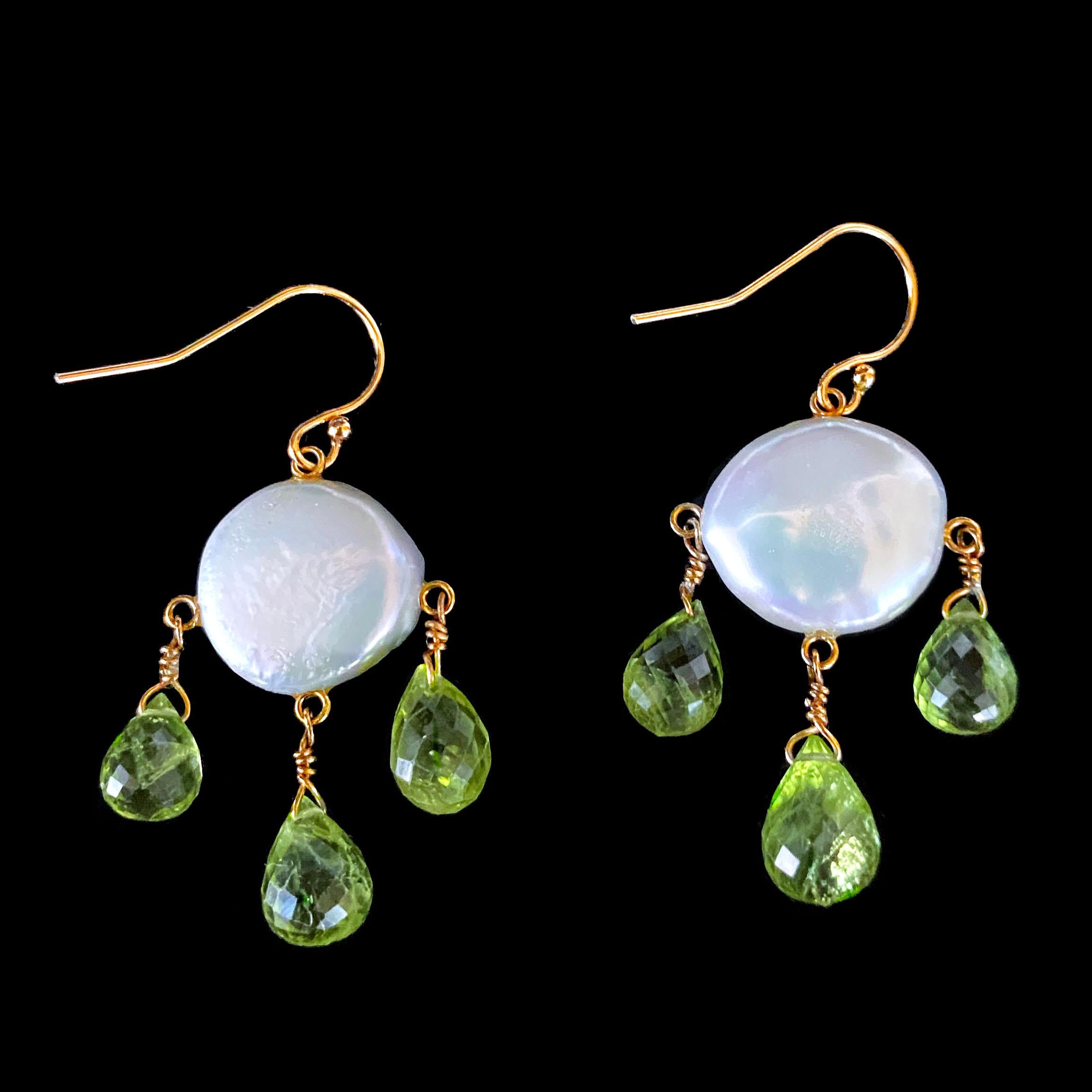 Playful pair of earrings by Marina J. These Earrings are made of two beautiful Flat Coin Pearls with a soft multi color iridescent luster. Three Teardrop shaped Faceted Peridots hang from the Pearl in a Chandelier like fashion. Due to the stone's