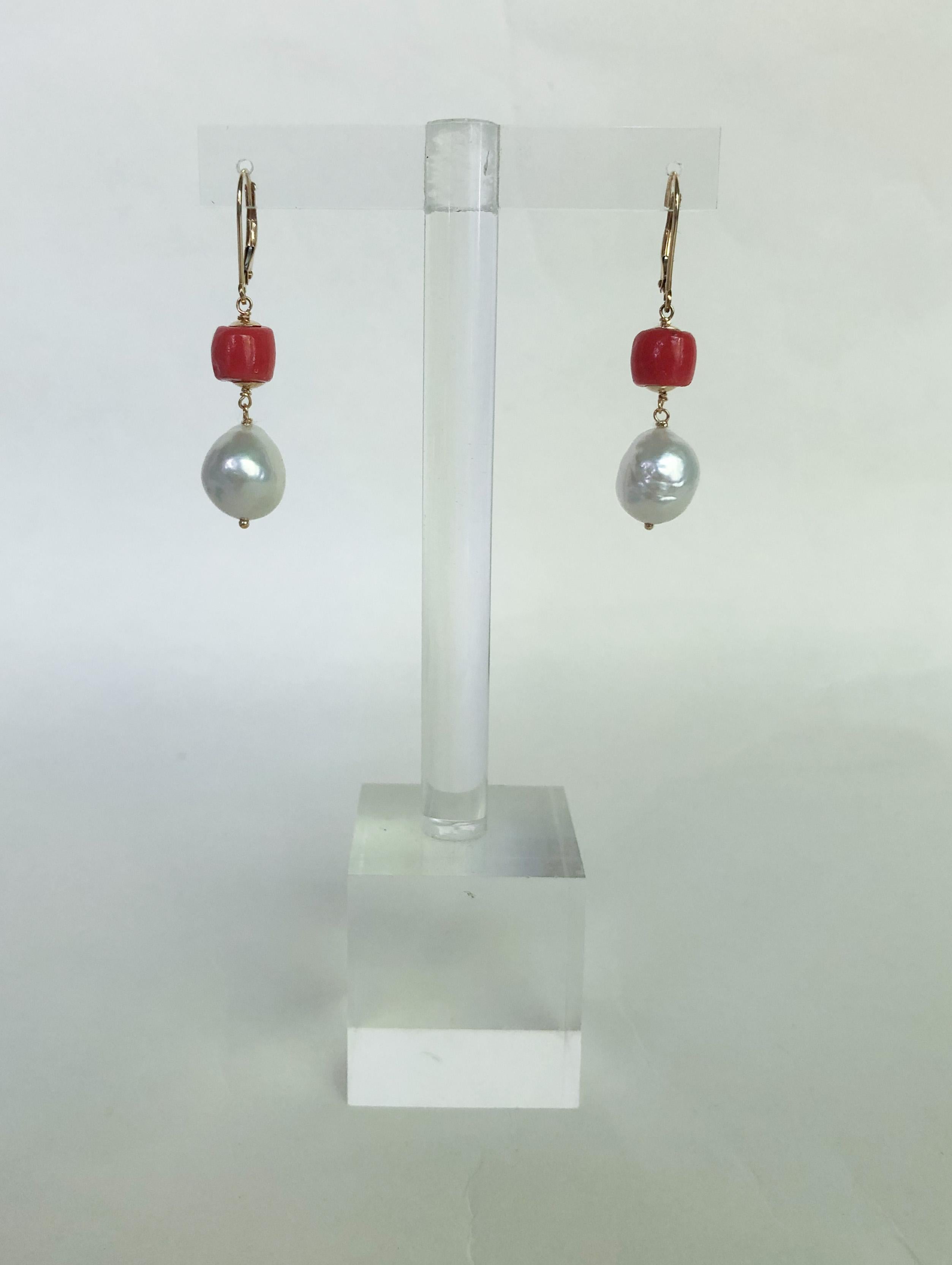 These elegant and dainty coral and white pearl earrings are highlighted with 14k yellow gold lever backs and wiring. They are the classic pearl earrings with vibrant coral to add a touch of color and vibrancy. They are 1 inch long, and embody