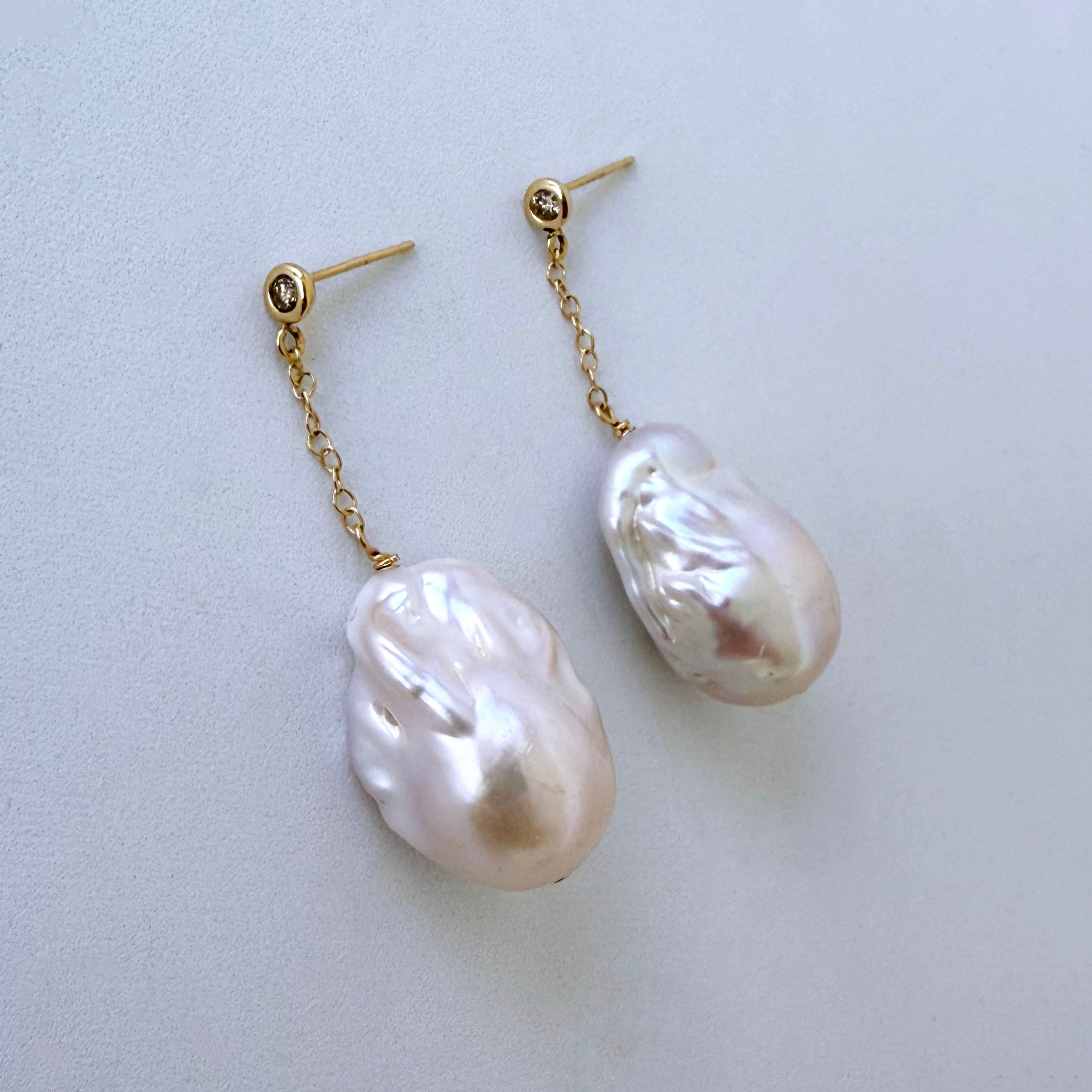 Gorgeous one of a kind pair made by Marina J. This pair features a beautiful 14k Yellow Gold set Diamond studs, from which large Baroque Pearls with vivid multi color iridescent sheen hang from 14k Yellow Gold chain. Earrings measure 1.25 inches