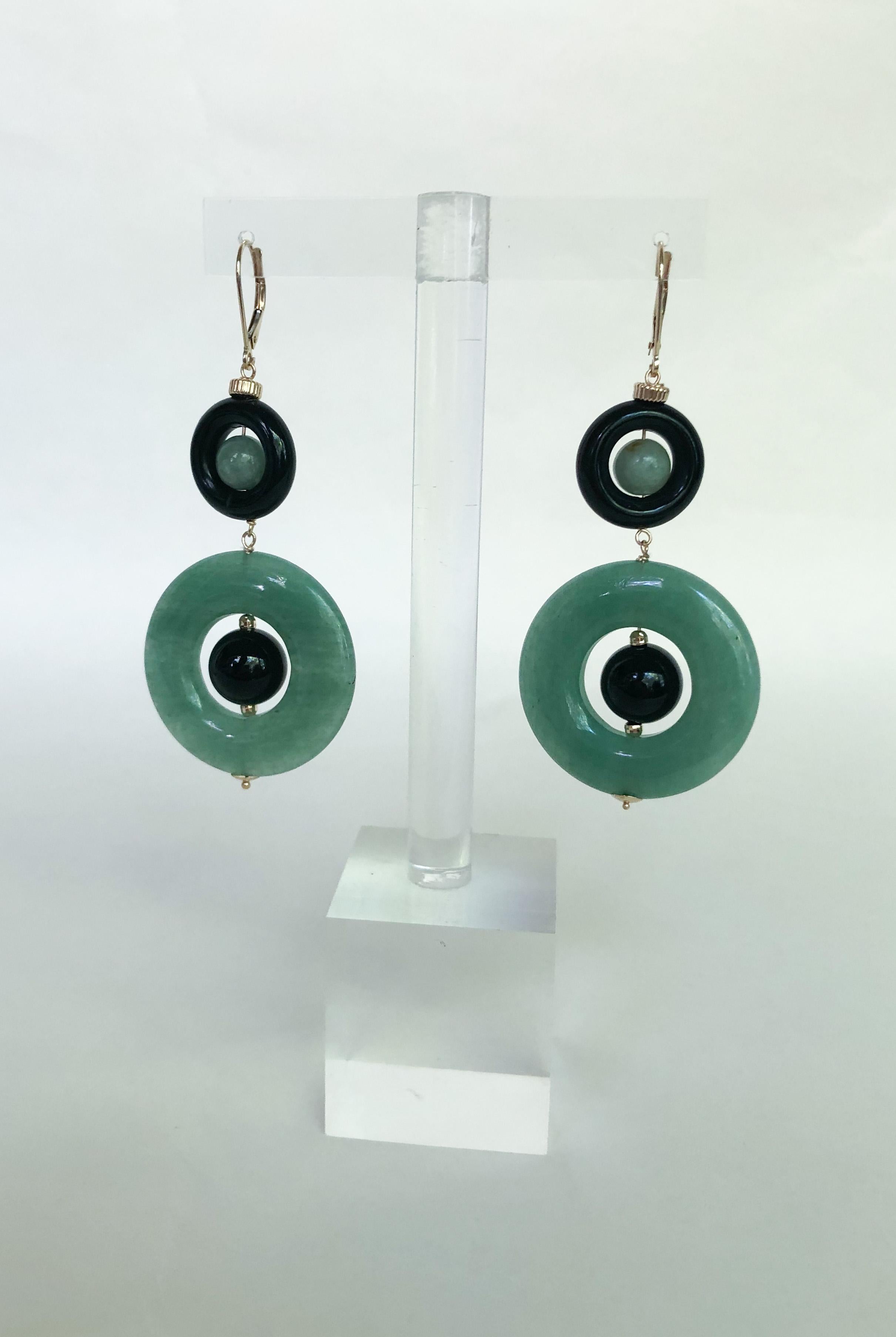 These elegant earrings are made with a jade ring, onyx ring, onyx circular bead, and jade circular bead. The onyx and jade contrast beautifully with each other, and gives the earrings a dramatic flare. The earrings are about 2 inches long, and