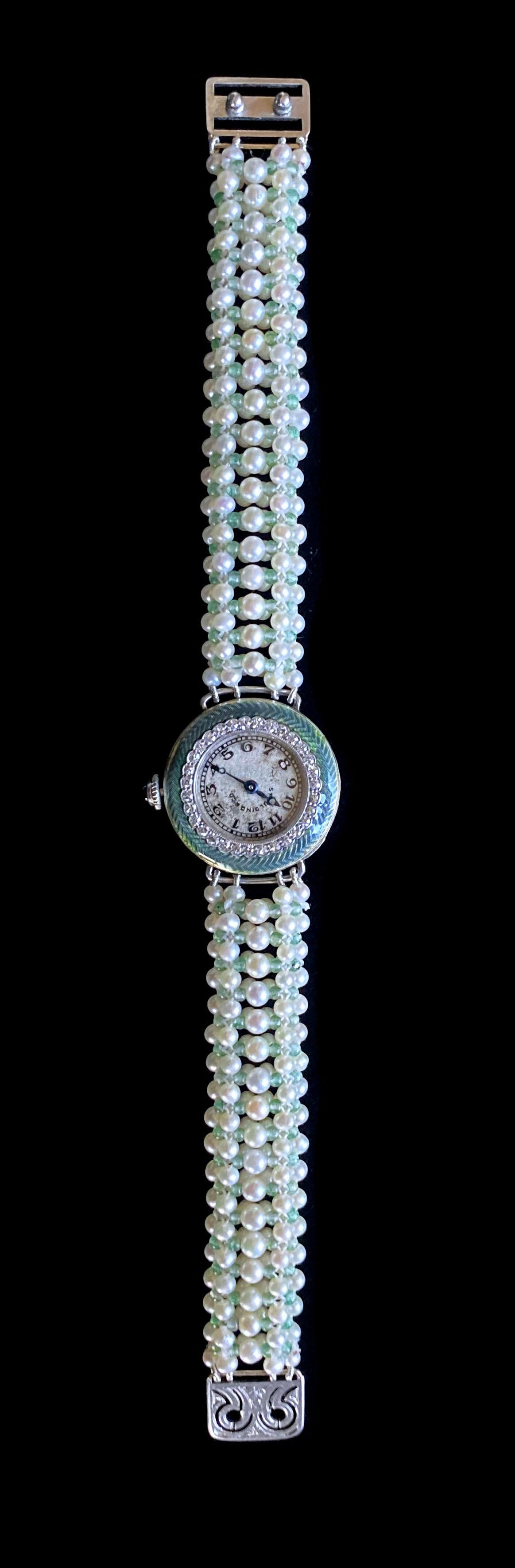 Gorgeous One of A kind watch by Marina J. An antique Diamond encrusted Edwardian Spaulding & Co Watch with Green Enamel detailing is reworked into a stunning modern piece. The watch is made of all white Platinum with a working dial on its side which