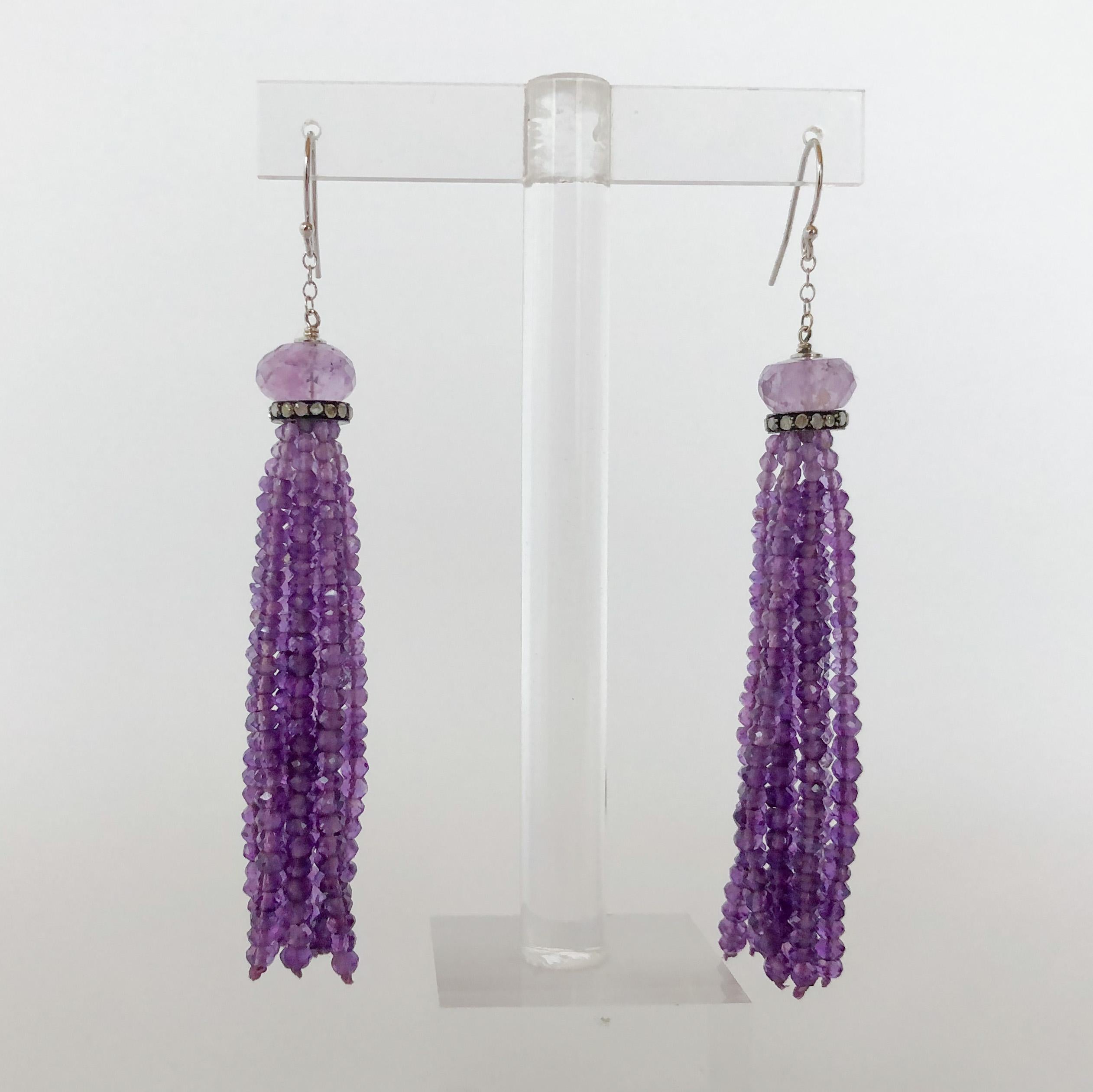 These gorgeous earrings are made of amethyst graduated beads from 2-4 mm in width. The earrings feature an 8 mm amethyst bead with a diamond encrusted roundel. They are 3 inches long and the fish hook backings are made of 14k white gold.